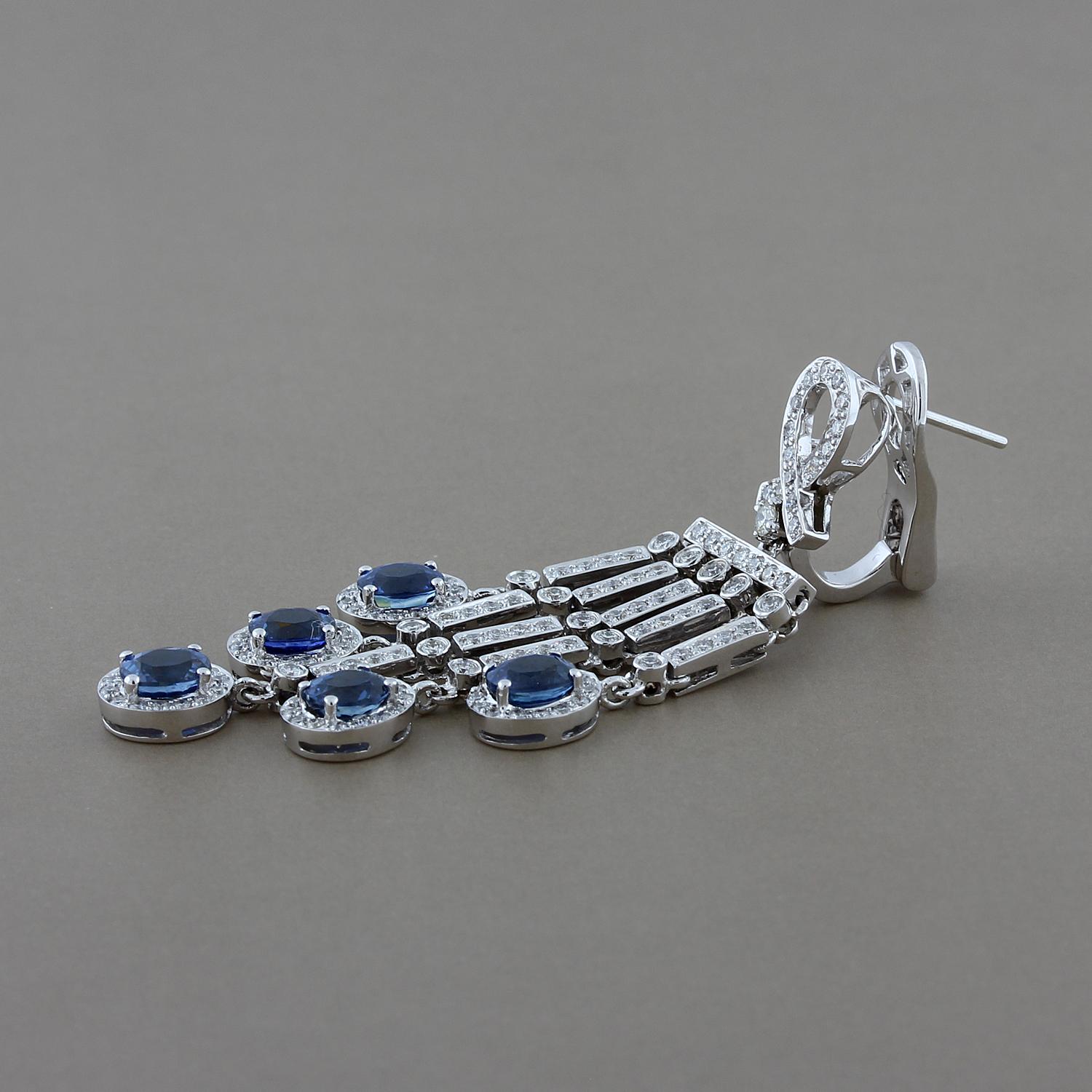 Sophisticated elegance! These earrings feature 5.43 carats of oval shape blue sapphires accented by 2.09 carats of round cut diamonds. These chandelier drop earrings are set in 18K white gold with omega clip backings.

Earring Length: 2.15