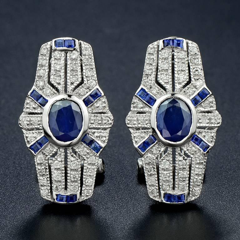 Oval Shape Thai Blue Sapphire 2 pieces 1.60 Carat in the center highlighted by 24 pieces 0.480 Carat French Cut Sapphire and sparkling with 80 pieces 0.40 Carat Diamond. This earring was Set on 18K White Gold Clip-on Style.

S-S (2-1.6 ct.), S9