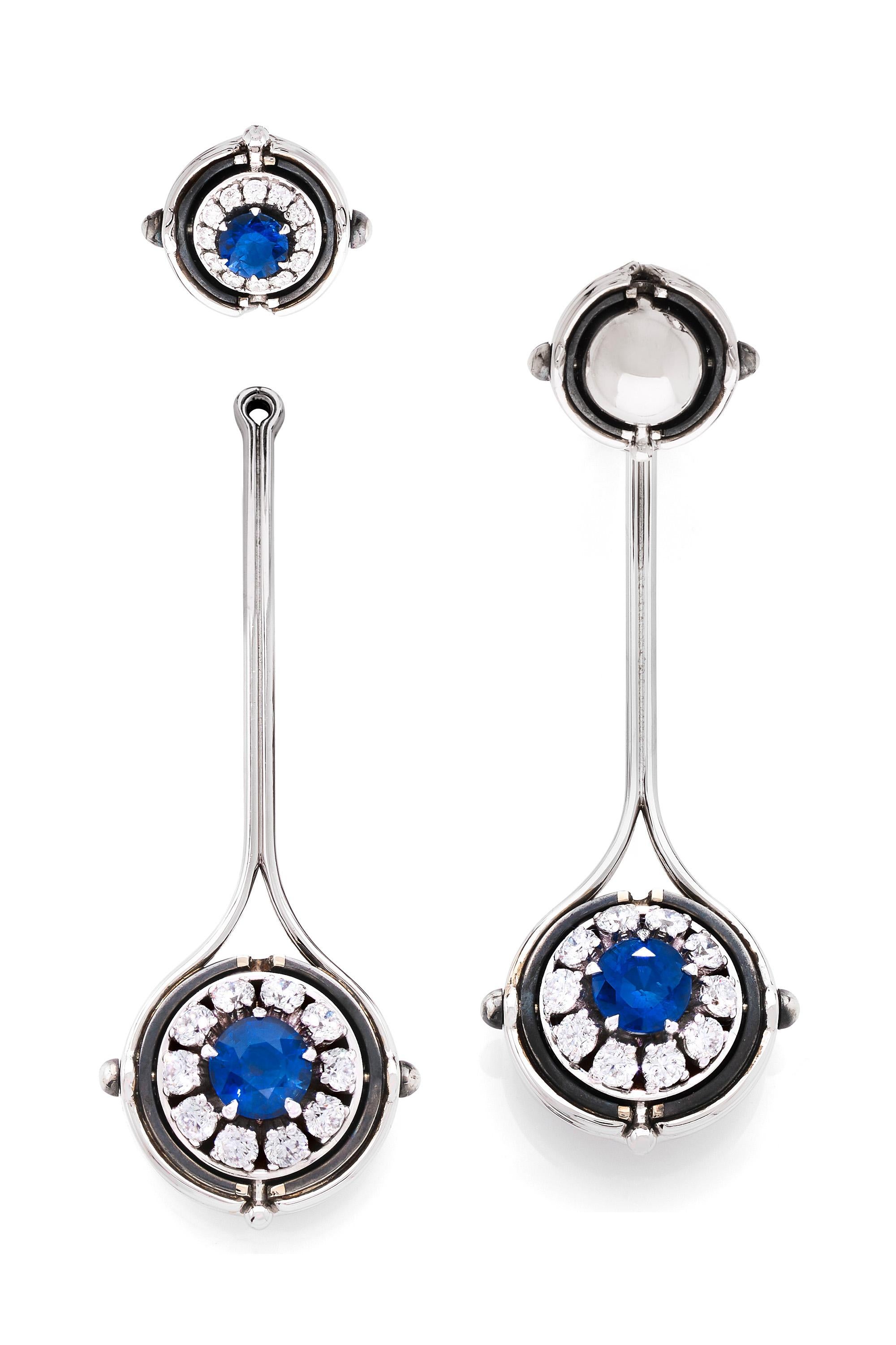 White gold and distressed silver earrings. Rotating spheres revealing a sapphire surrounded by diamonds.

The pendants and the studs can be sold separately.

Details : 
4 Sapphires: 2.53 cts
32 Diamonds: 1.51 cts
18k White Gold: 23 g
Distressed