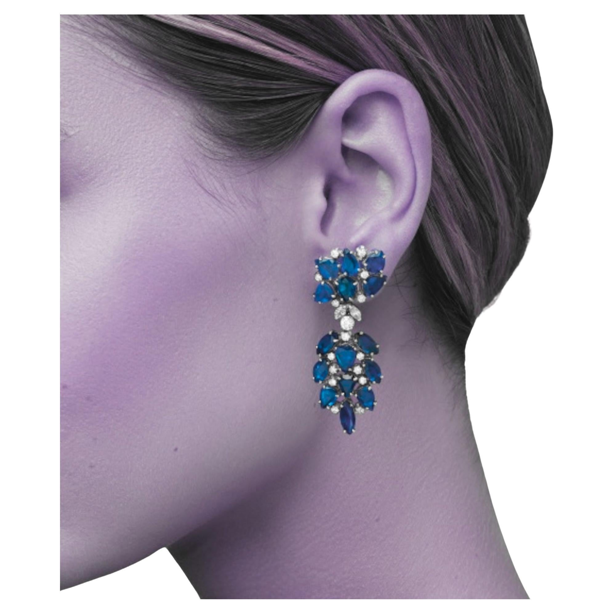 Pair of blue sapphires and Diamond Earrings
Each set with pear and marquise shaped sapphires, accented by brilliant and marquise-cut diamonds, mounted in 18K white gold, posts and hinge back fittings, pendants detachable.