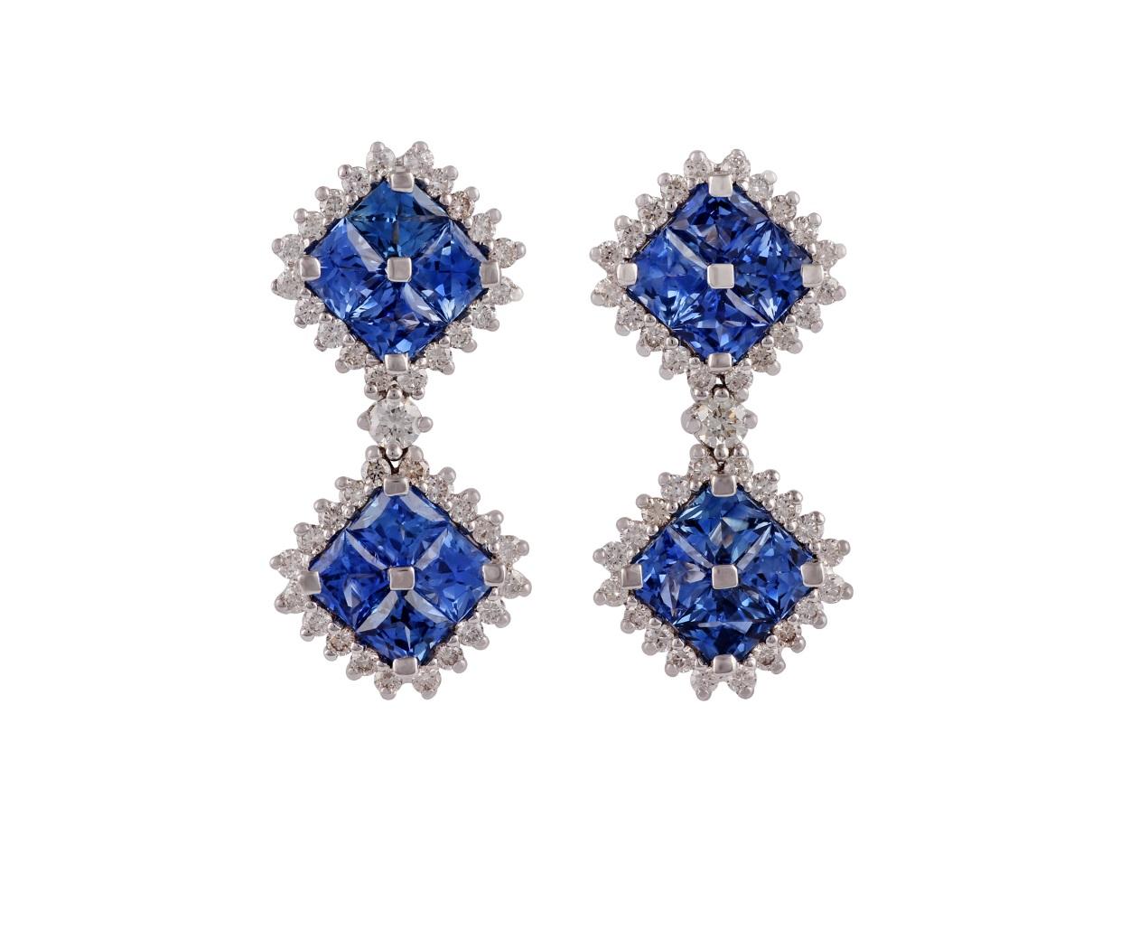 These are an elegant pair of earrings studded in 18k white gold with 16 pieces of square shape blue sapphires weight 2.93 carat with 82 pieces of round shaped diamonds weight 0.73 carat, these entire pair of earrings studded in 18k white gold weight