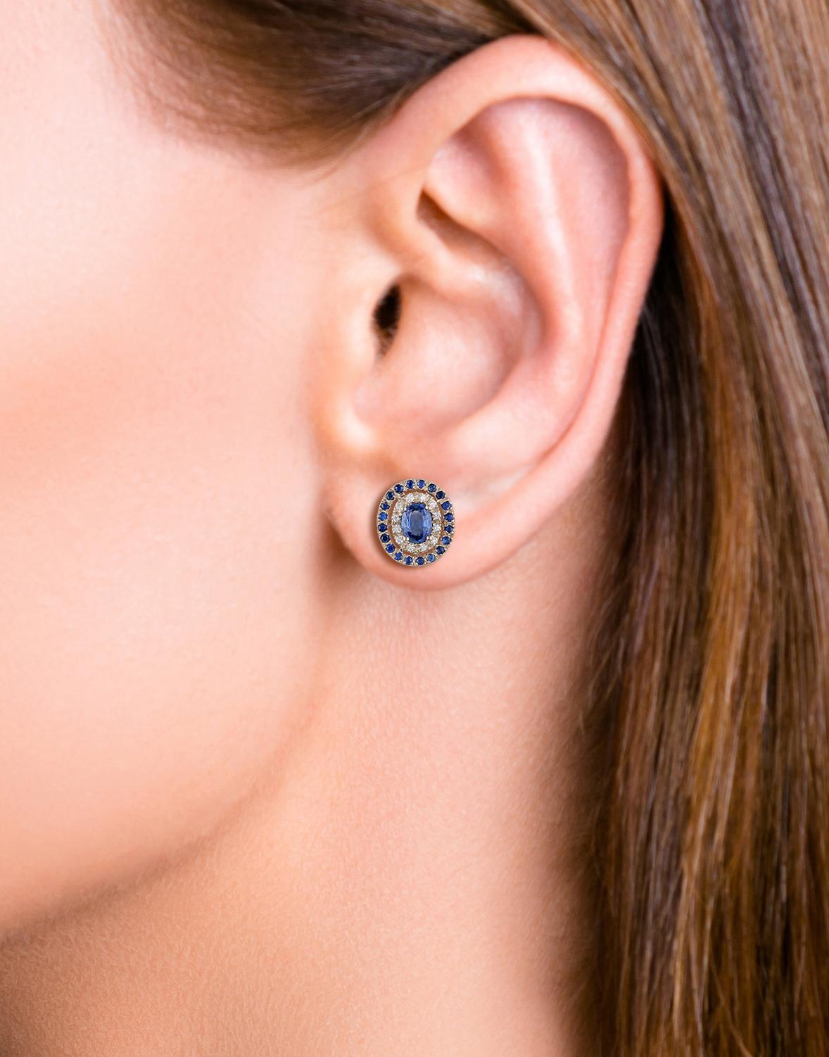 Oval Cut Blue Sapphire and Diamond Earrings Studded in 18 Karat White Gold