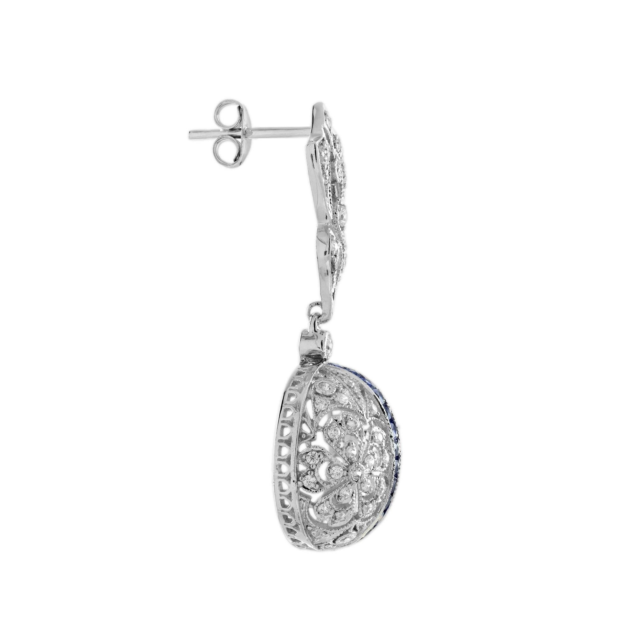 Questi orecchini in stile Art Deco con zaffiro blu e diamanti trasformano ogni momento in qualcosa di veramente speciale. I ricchi zaffiri blu, abbinati ai radiosi diamanti, creano un contrasto abbagliante che cattura lo sguardo a ogni movimento. Il