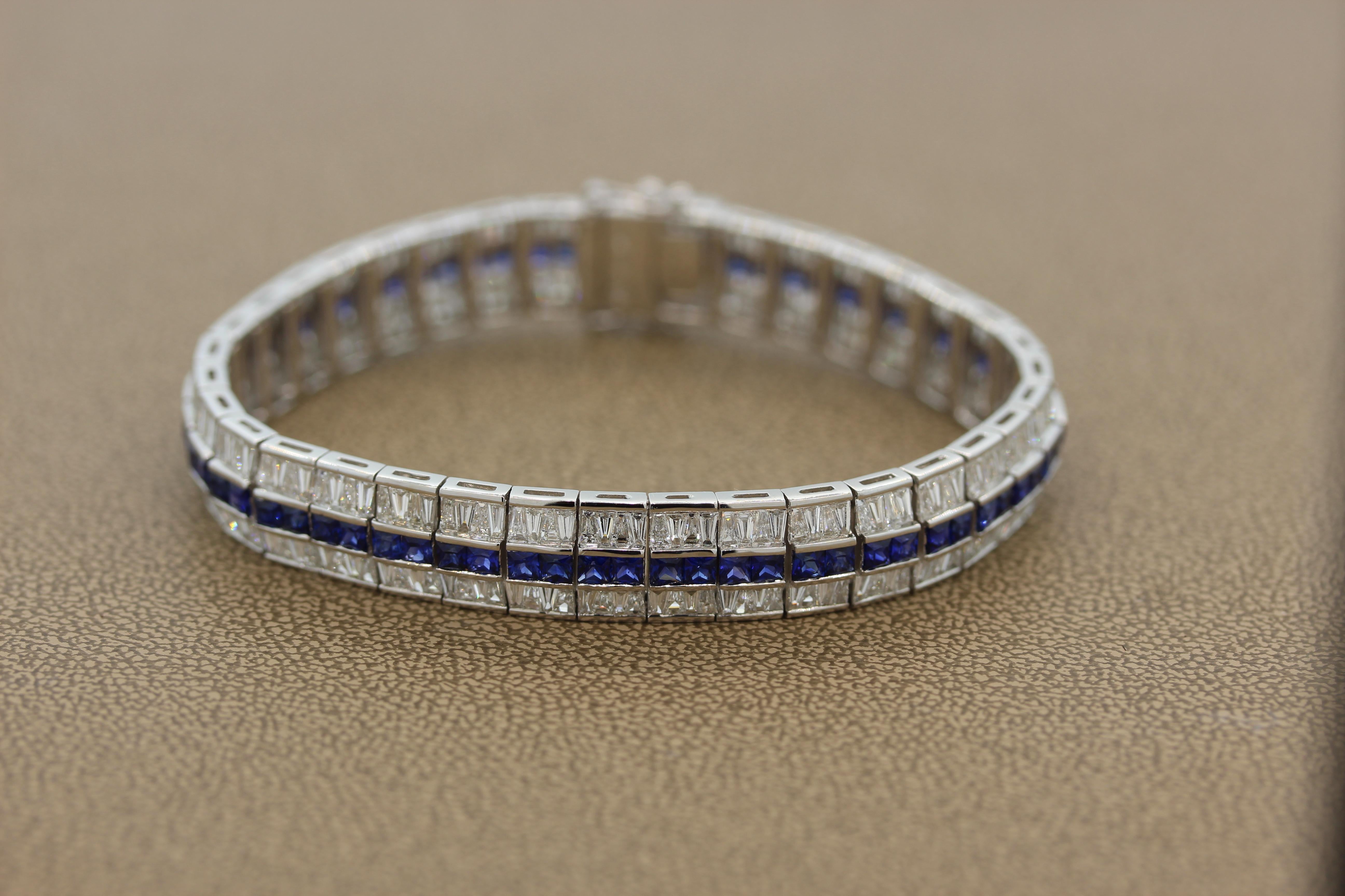 An expertly crafted bracelet featuring approximately 4.00 carats of royal blue sapphires. The princess cut sapphires are channel set between 10.00 carats of VS quality tapered baguette cut diamonds. This beautiful 18K white gold bracelet has a