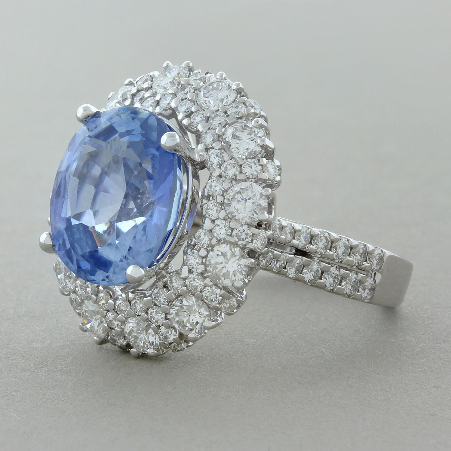 This glamorous ring features a 7.43 carat oval shaped blue sapphire with a beautiful sky-blue color. The sapphire is accented by a double halo of 2.00 carats of round brilliant cut diamonds set in 14K white gold.

Ring Size 6.5 (Sizable)
