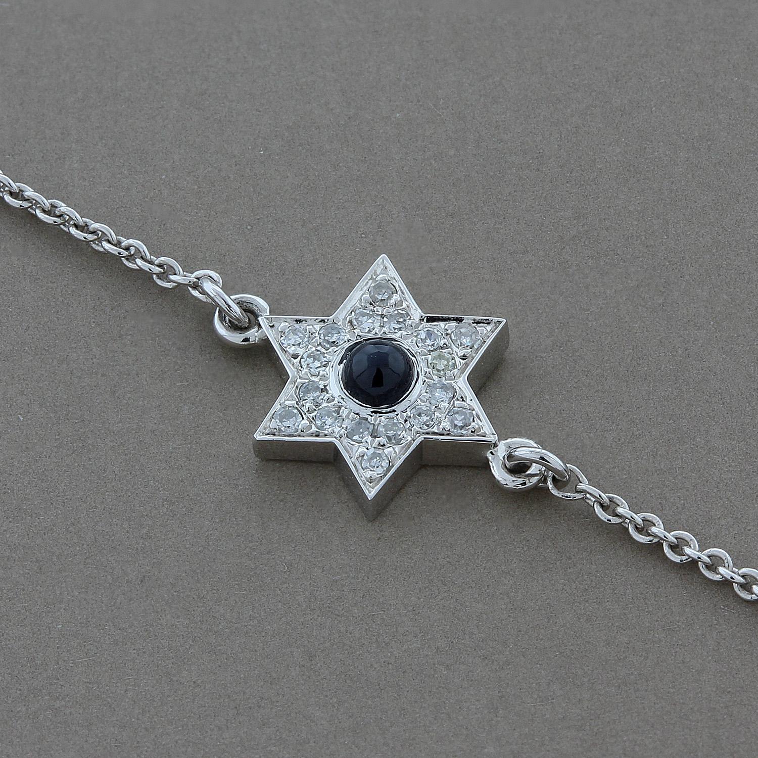 A star with a single round cabochon blue sapphire centered around 0.05 carats of pave set diamonds. Pave set in 14K white gold, this bracelet is a great everyday piece that can be worn alone or stacked.

Adjustable chain with sizing loops to fits
