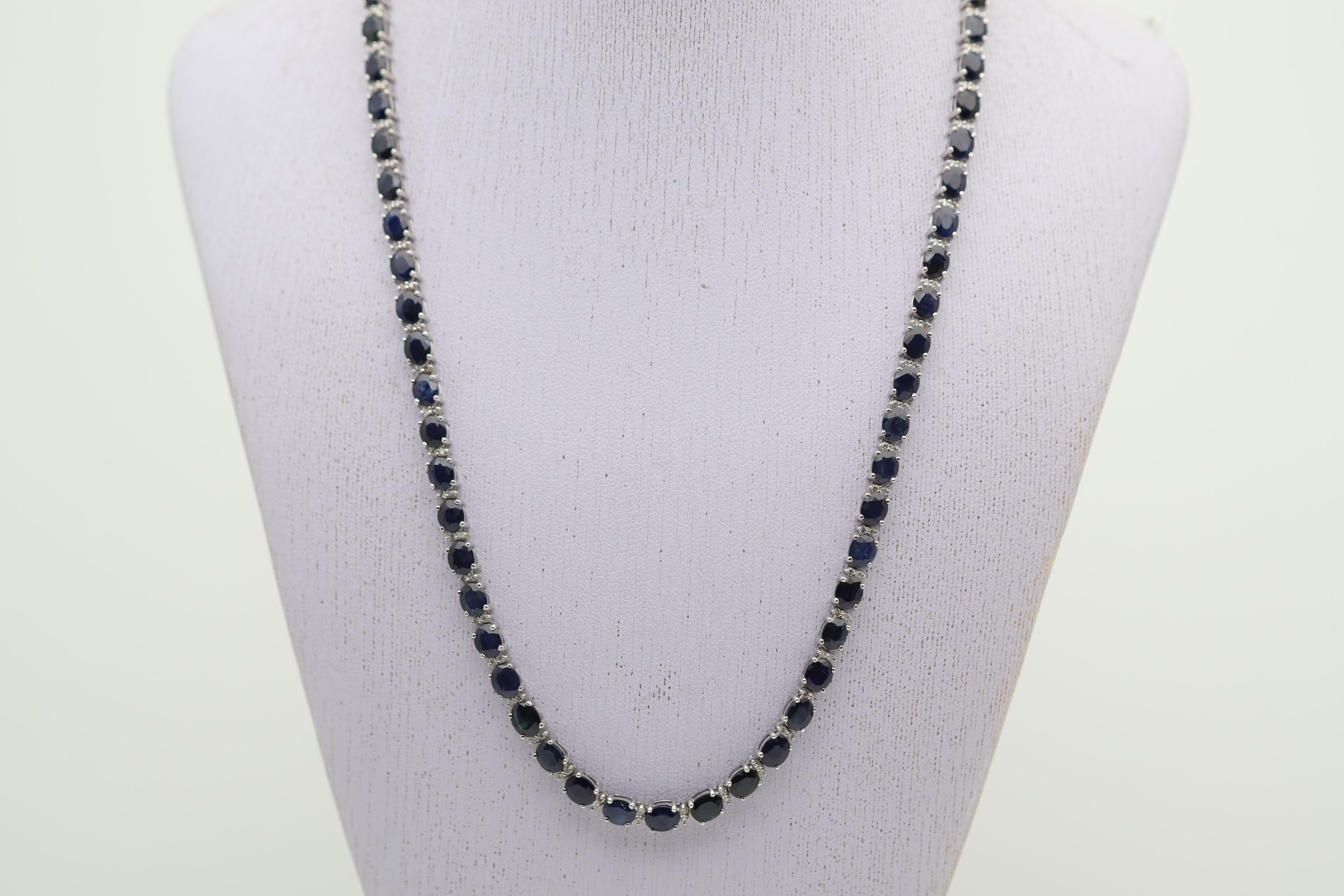 A classic and chic tennis necklace featuring a straight row of sapphires and diamonds. The sapphires weigh a total of 25 carats and have a rich deep blue color. They are complemented by 1.00 carat of round brilliant-cut diamonds set in pairs between