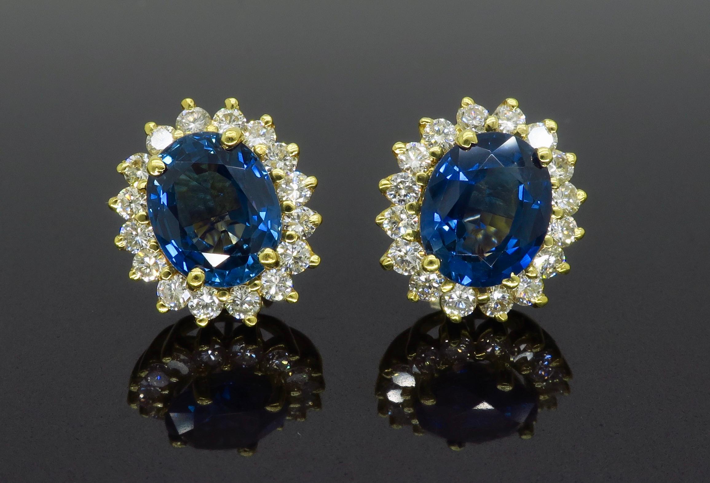 Blue Sapphire and 1.60CTW Round Brilliant Cut diamond halo style earrings in yellow gold.

Gemstone: Blue Sapphire & Diamond
Gemstone Carat Weight: Two Approximately 9.7x7.8mm Blue Sapphires
Diamond Carat Weight:  Approximately 1.60CTW
Diamond Cut: