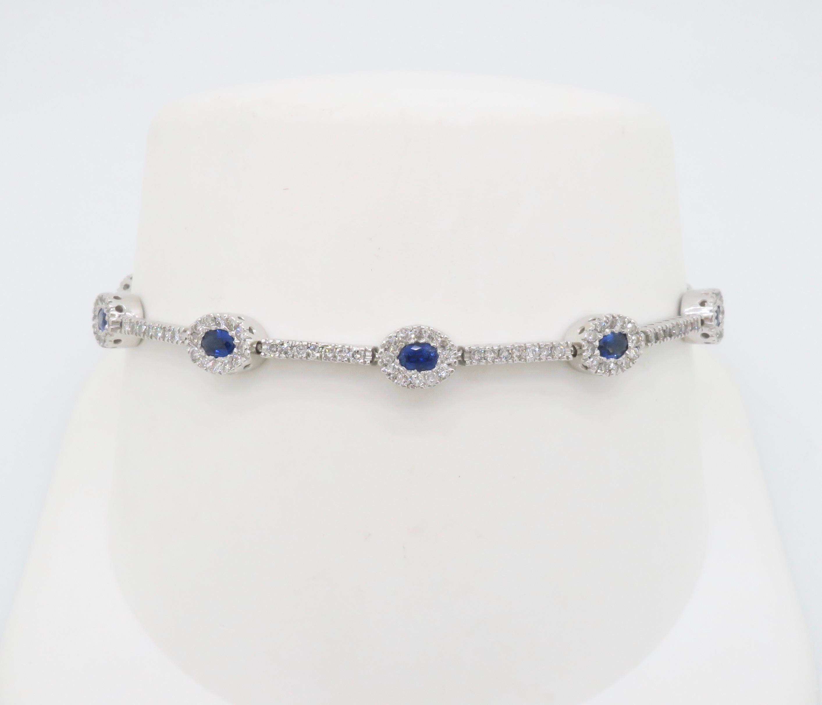 Oval Cut Blue Sapphire & Diamond Halo Line Bracelet in White Gold For Sale