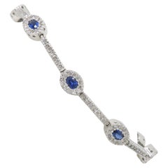 Blue Sapphire & Diamond Halo Line Bracelet in White Gold 