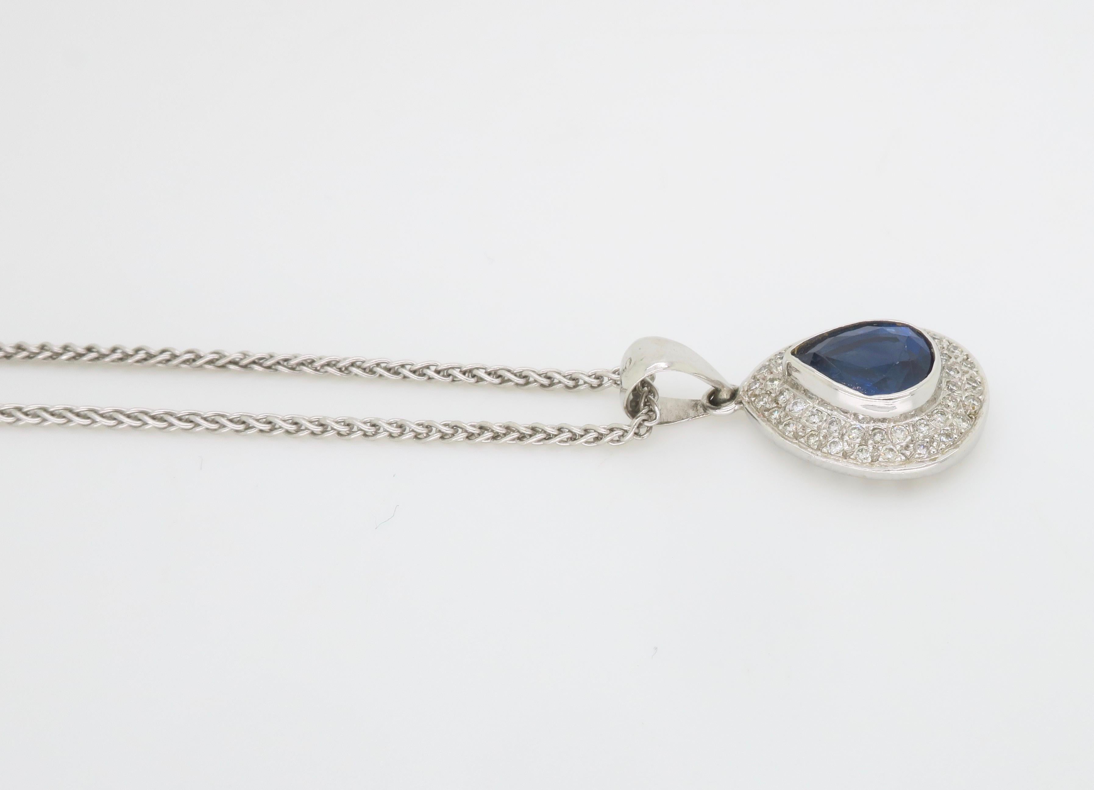 Blue Sapphire and Diamond halo pendant necklace crafted in 18k white gold. 

Gemstone: Sapphire & Diamond 
Sapphire Weight: Approximately 1.70CT
Diamond Carat Weight: Approximately .25CTW
Metal: 18K White Gold 
Marked/Tested: Stamped “750