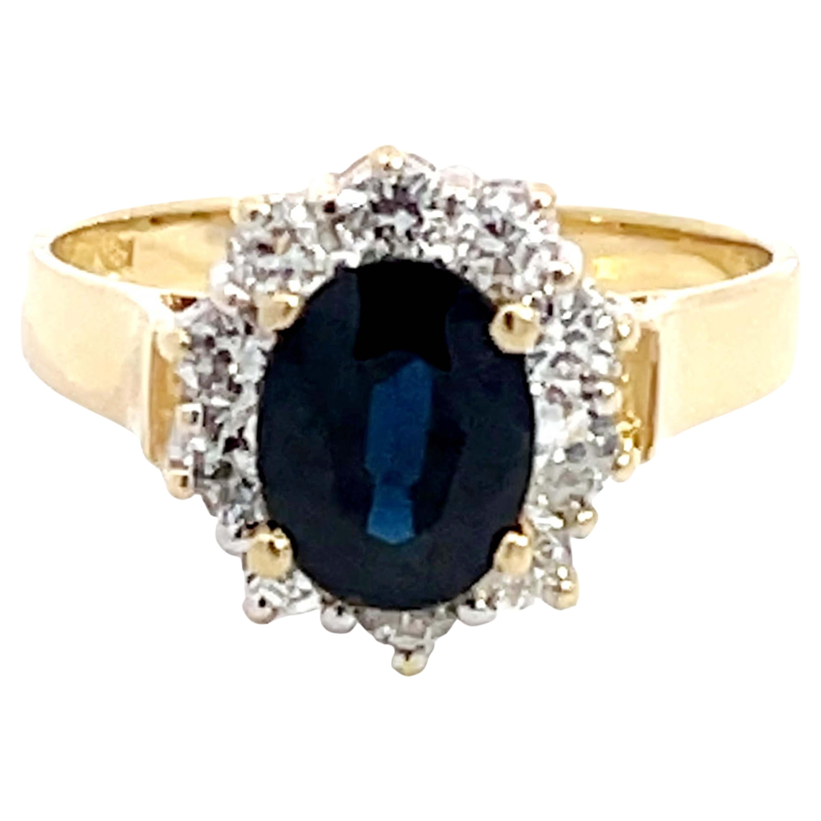 Anello aureola con zaffiro blu e diamante in oro giallo 18 carati