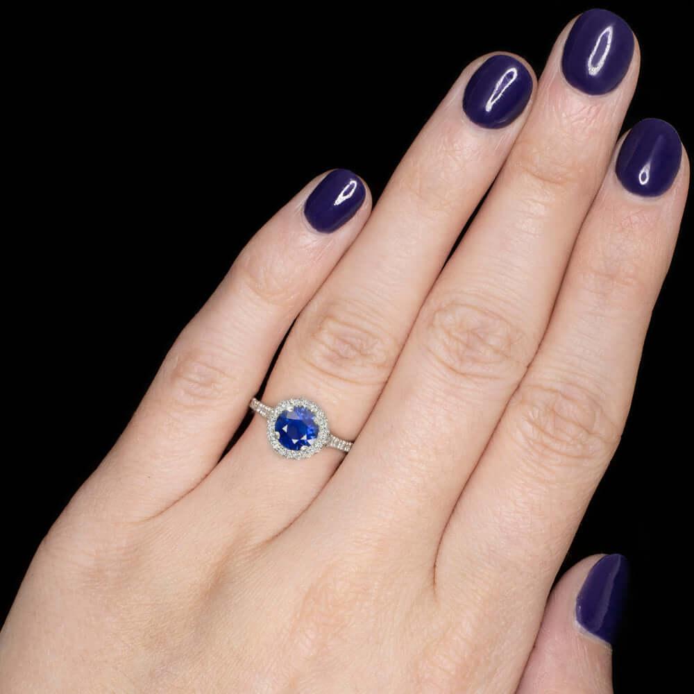  striking and high quality sapphire and diamond ring has an eye catching, glamorous design featuring a royal blue sapphire in a luxurious, diamond encrusted platinum setting! The 1.14ct round cut sapphire center is a gorgeous royal blue color. It is