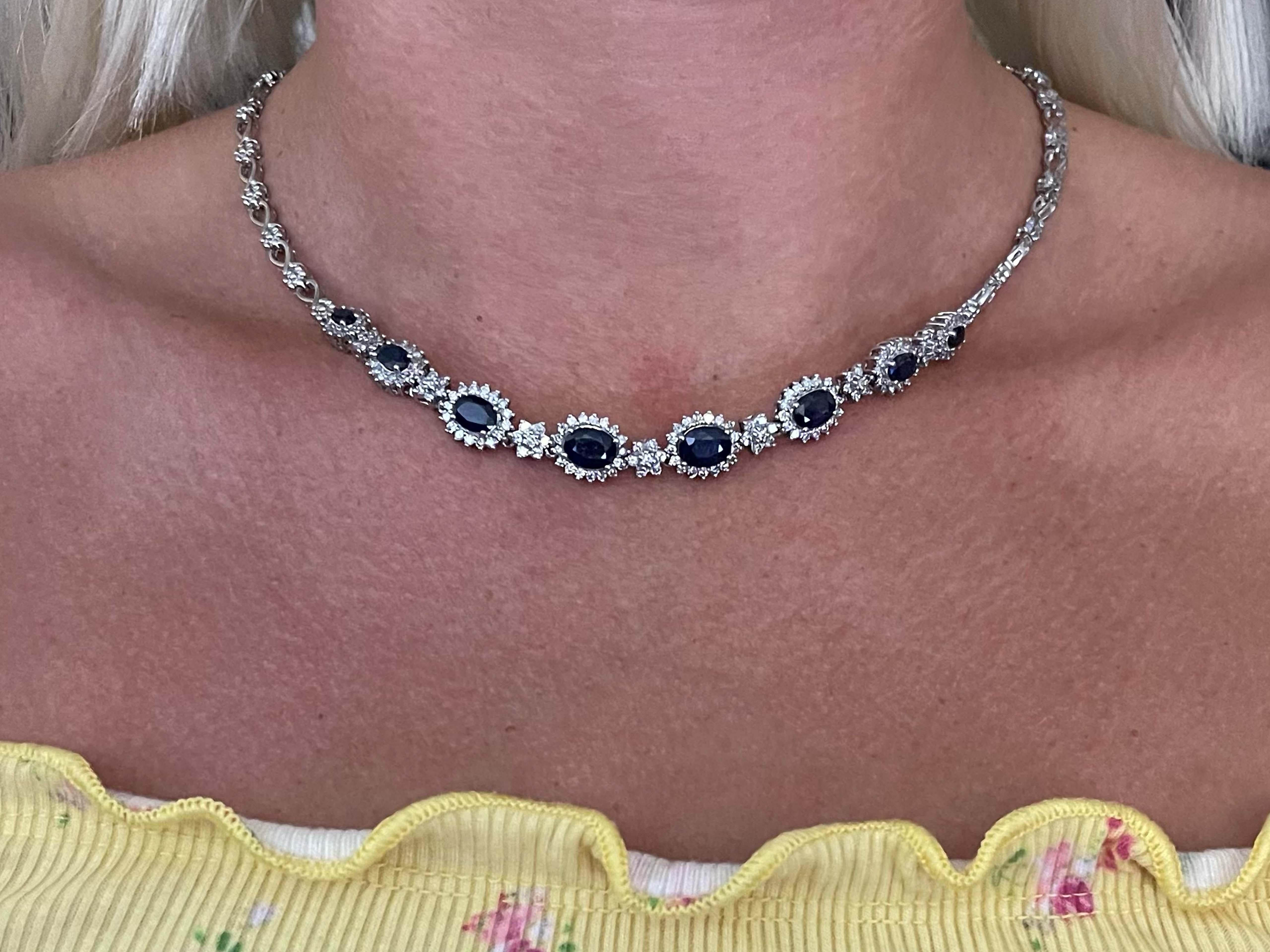 This stunning blue sapphire and diamond necklace is sure to turn heads. Made with 8 oval sapphires surrounded by diamond halos, the sapphires weigh 6.32 carats. Altogether the necklace has 167 diamonds. The diamonds are G-H, SI and weigh 1.08