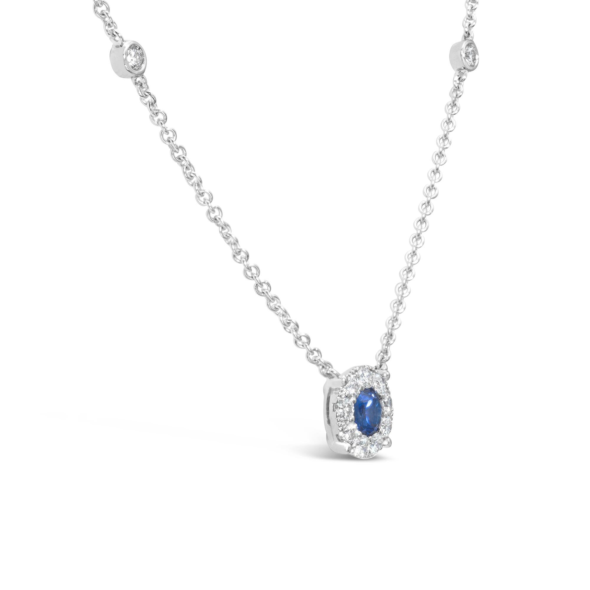 A classic pendant necklace, showcasing a 0.34 carat round cut blue sapphire embellished with a halo of round cut diamonds weighing 0.13 carat total. Accented by an 18K white gold diamonds by the yard chain, 16 inches in length. 

Roman Malakov is a