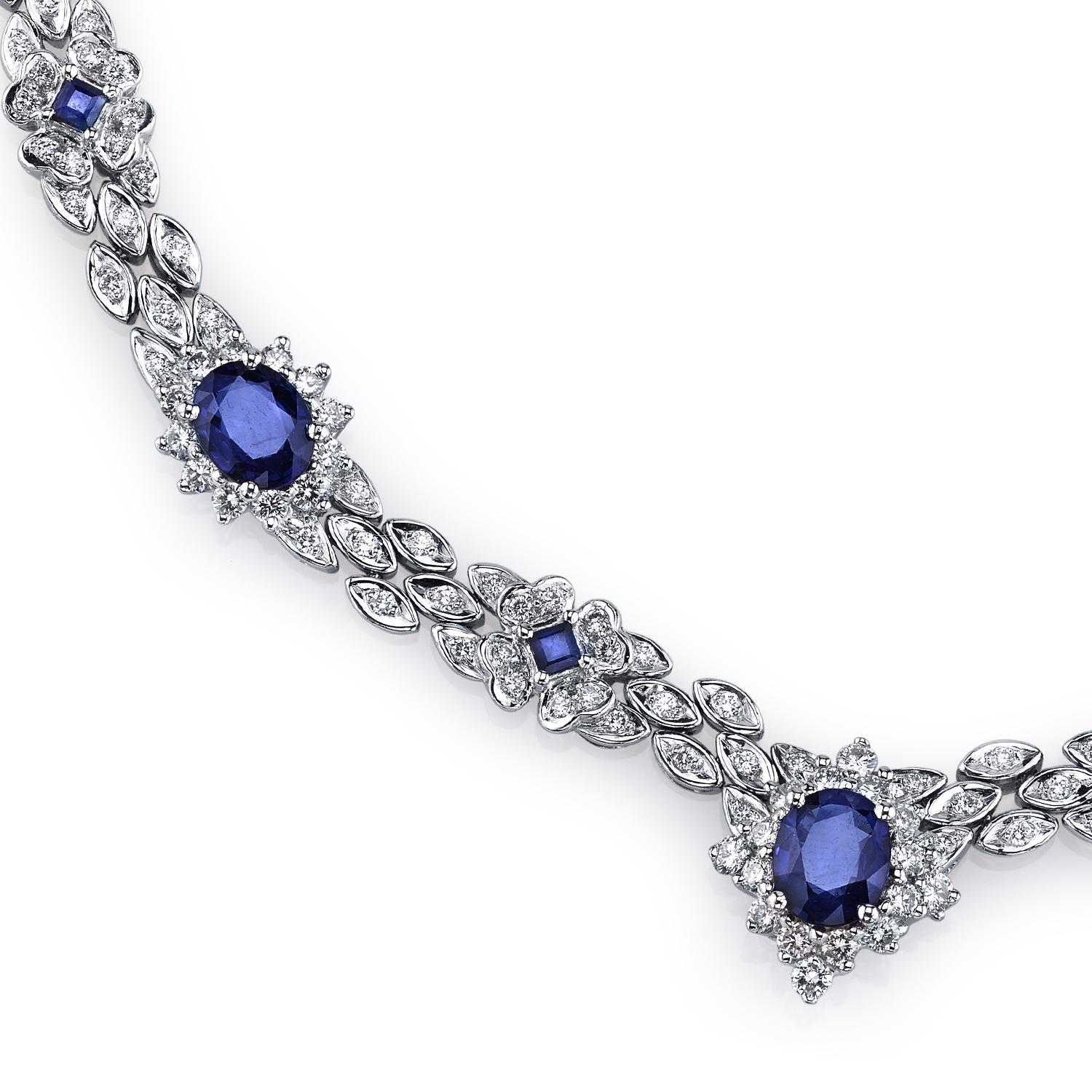 A dazzling necklace featuring 6.48 carats of vivid blue sapphires. The oval and princess cut blue sapphires form flower clusters as they are complemented by 5.86 carats of VS quality full-cut diamonds. Set in platinum.

Necklace Length: 16 1/4