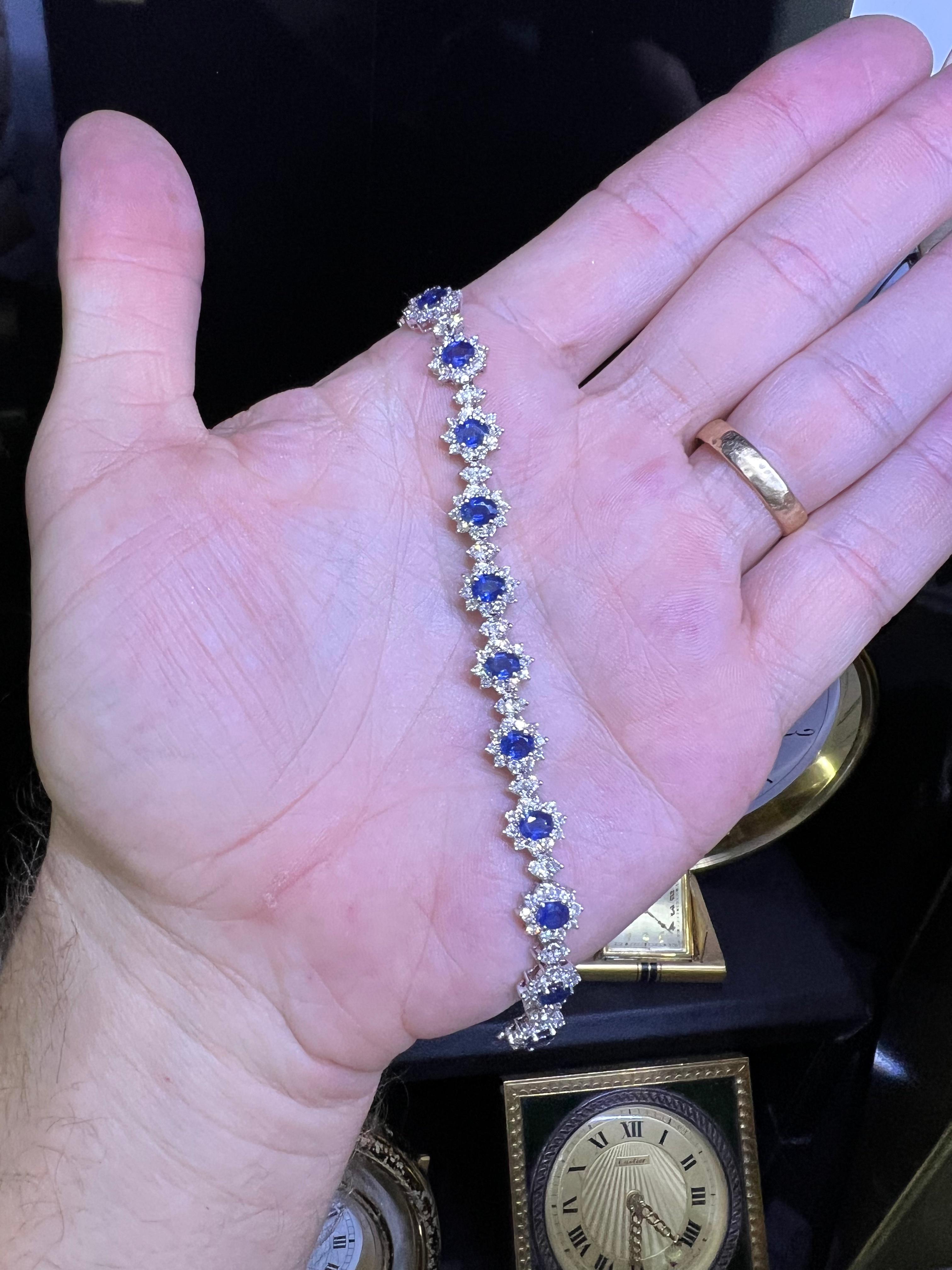 Beautiful bracelet crafted in 18k white gold. The bracelet is set with natural blue sapphires and earth mined natural diamonds. 
The bracelet is set with 6.50 carats of gemstones. The diamonds highlight the design showing scintillation throughout as