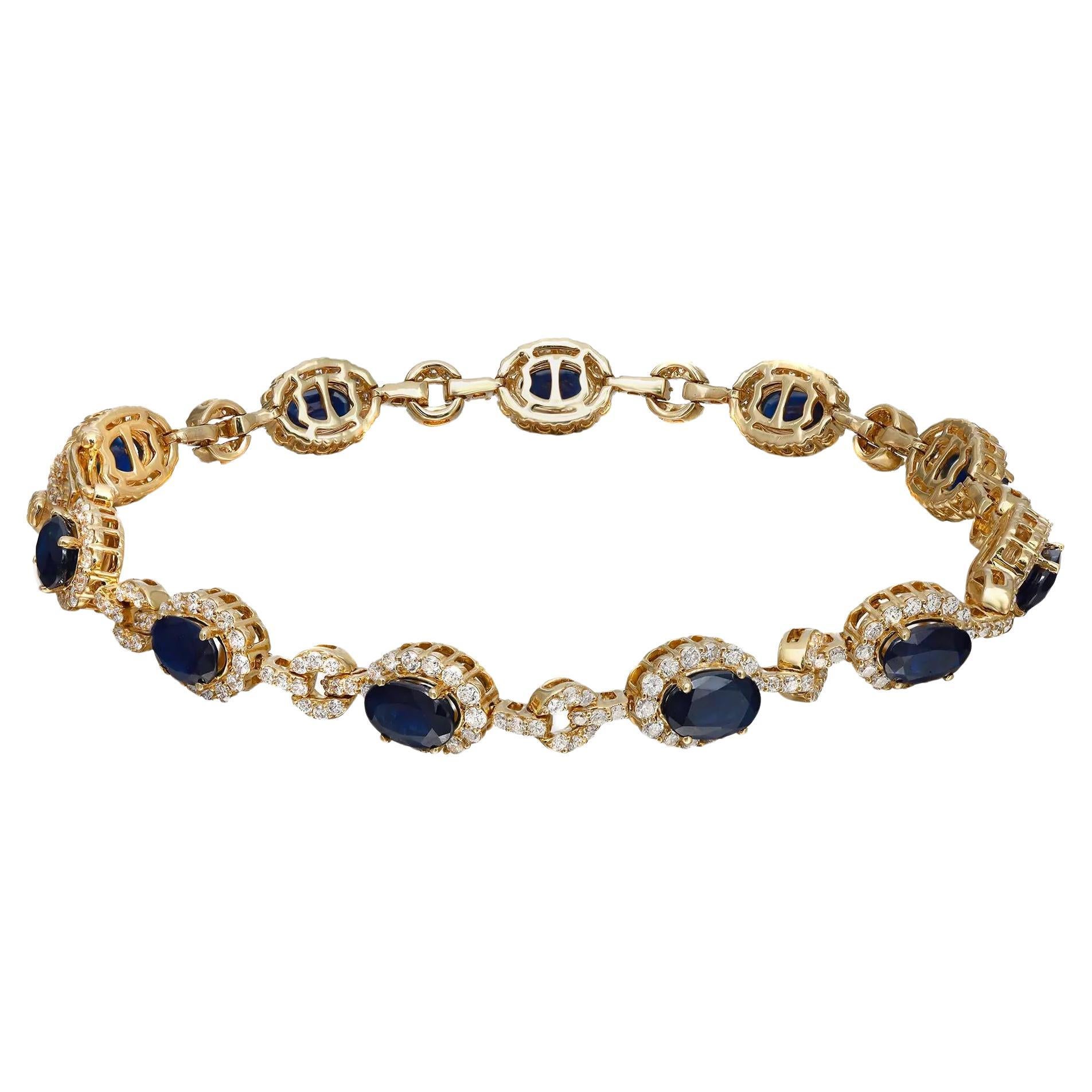 This stunning and exemplary bracelet is crafted in 14K yellow gold. Starring 11 radiant prong set oval cut Blue Sapphires, set with a halo of bright white round cut diamonds and pave diamond accents on the links. Total diamond weight: 2.09 carats.