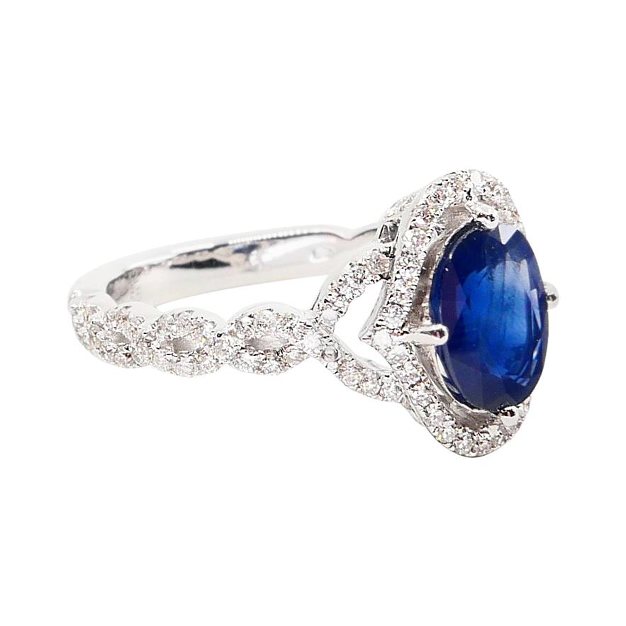 Oval Cut Blue Sapphire and Diamond Twist Ring, 18 Karat White Gold