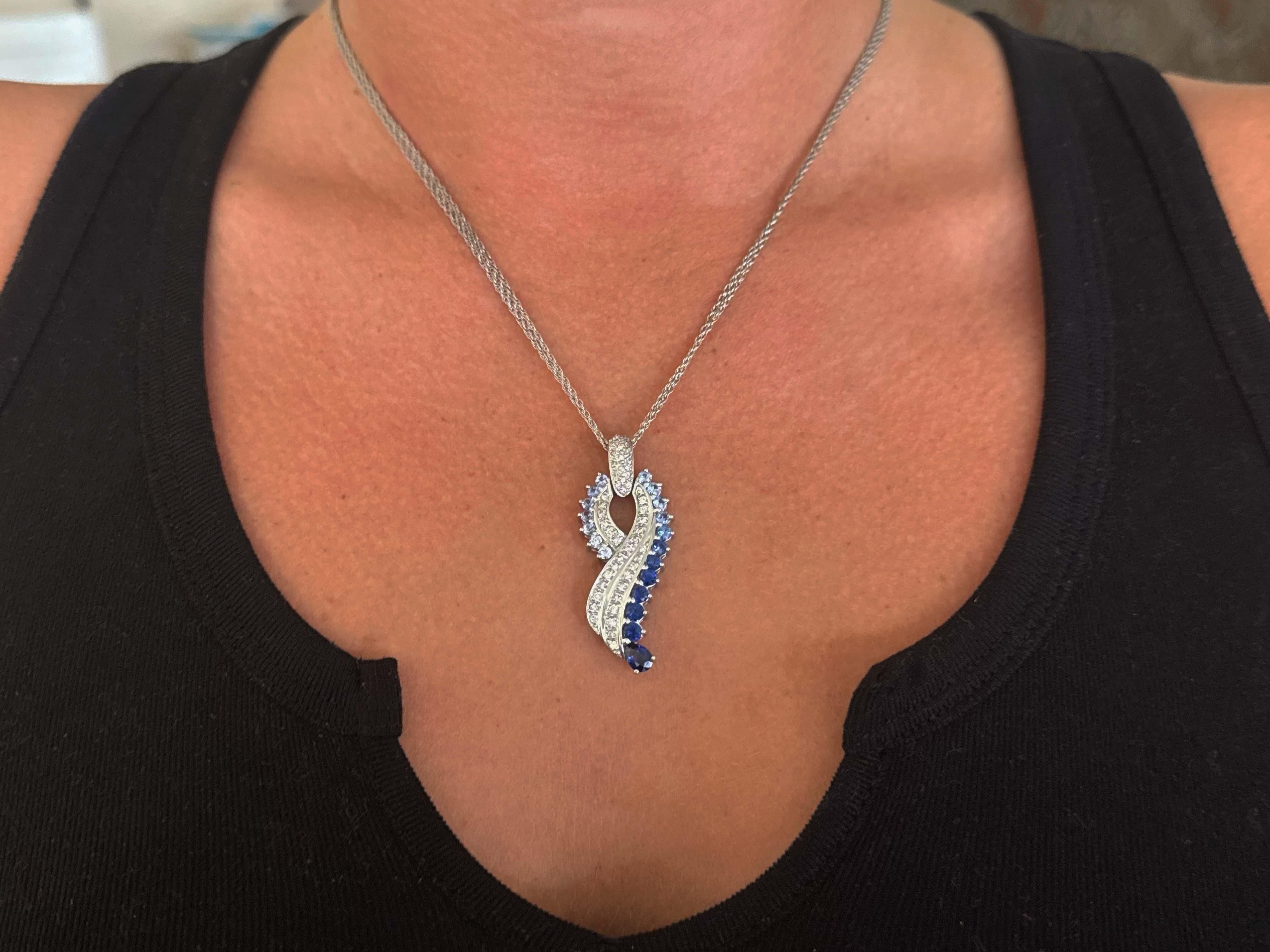 Item Specifications:

Metal: 14k White Gold

Diamond Count: 30 (pendant) + 19(bail)= 49 diamonds total

Diamond Total Carat Weight: 0.50 carat

Diamond Color: G-H

Diamond Clarity: SI1-SI2
​
​Sapphire Count: 18 round + 1 pear shaped 
​
​Sapphire