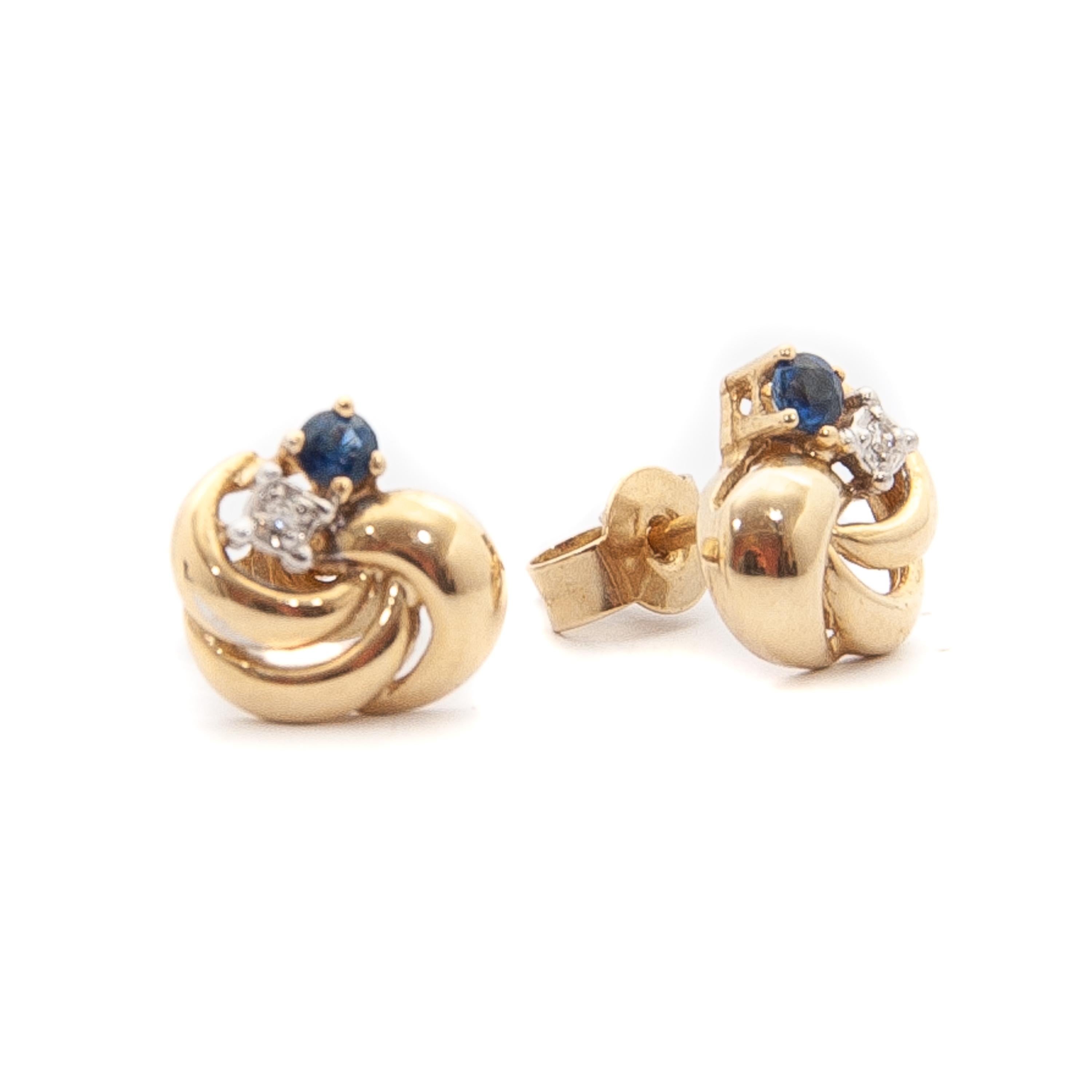 These earrings feature a blue sapphire and brilliant cut diamond set on top within a love knot design. The sapphire and diamond are set in a swirling 14k gold knot and with a post and push back fitting. They are super wearable with any outfit or can