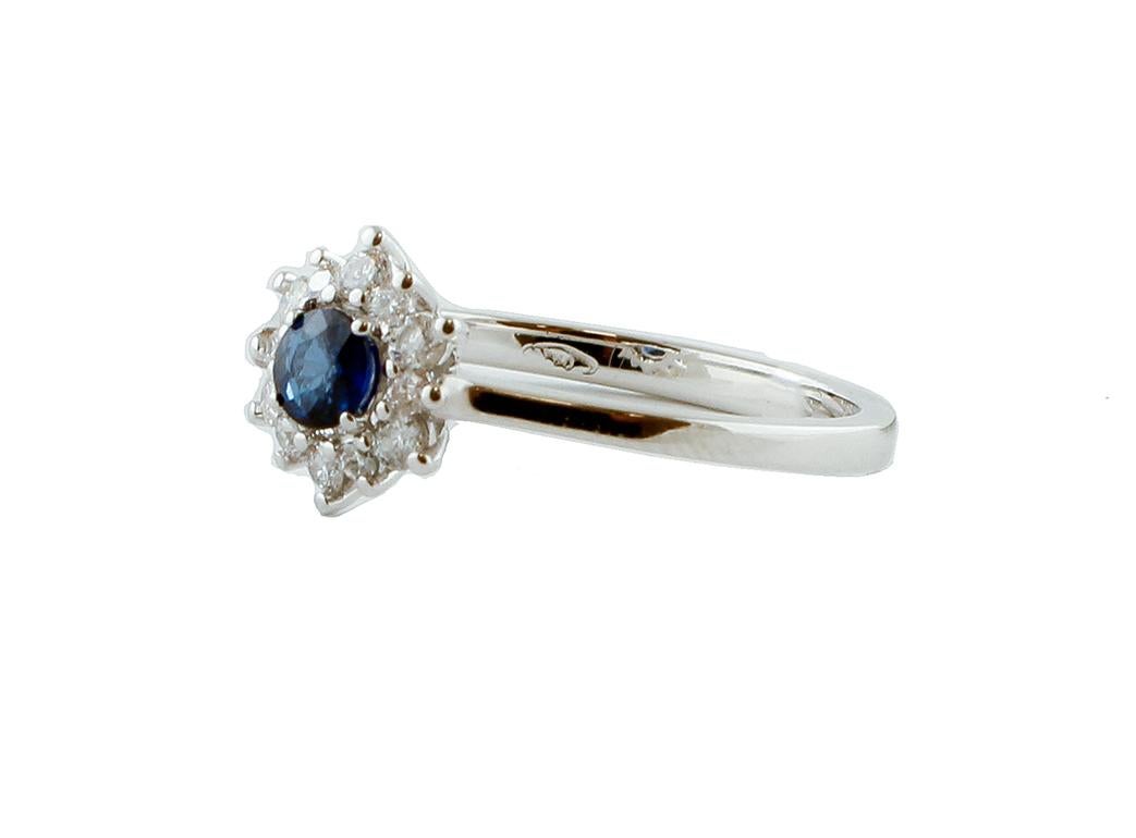 Beautiful engagement ring in 18 kt white gold structure mounted, in the central part, with a round blue sapphire. It is surrounded by a crown of little white diamonds.
This ring is totally handmade by Italian master goldsmith.
Diamonds 0.26 ct,