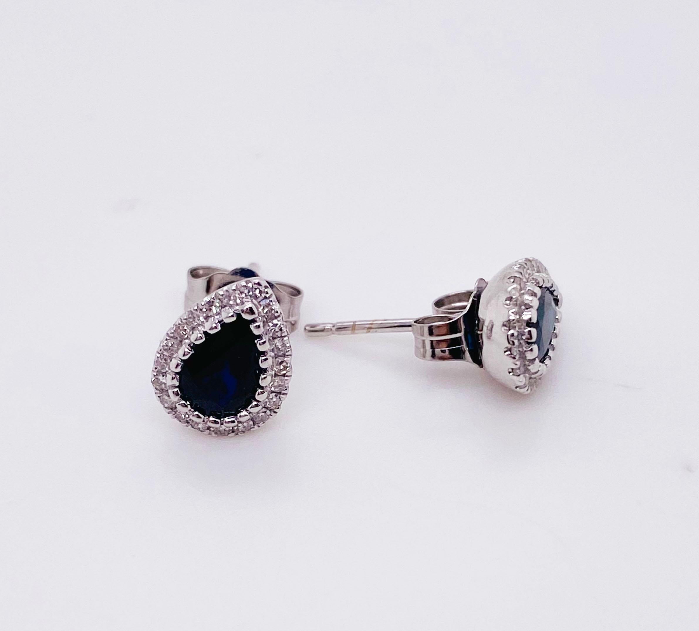These lovely blue sapphire earrings are a stud style that goes great on any earlobe! The earrings and posts are all 14 karat white gold and this enhances the twenty diamonds that go around each sapphire. The diamonds are all full cut with 58 facets