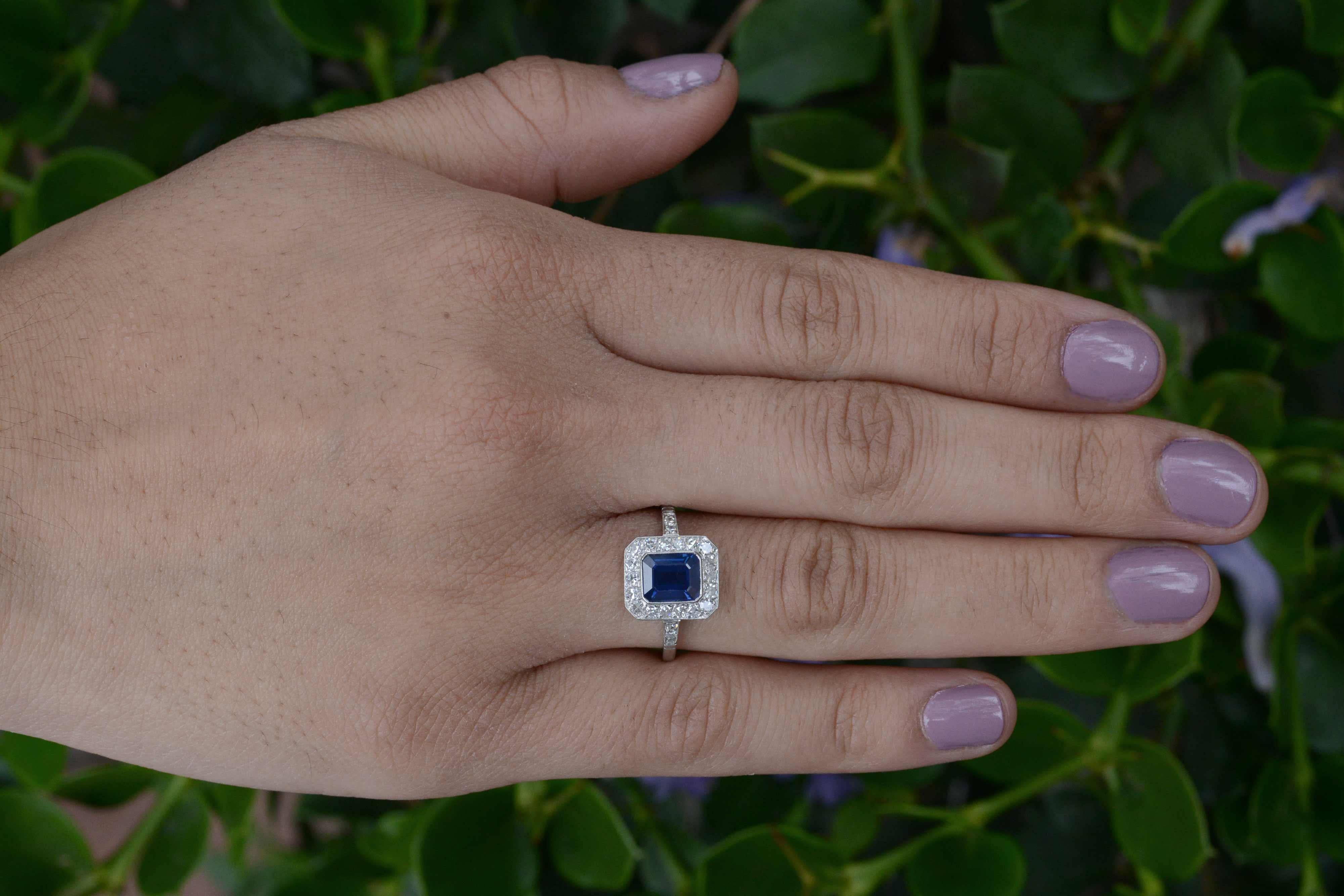 The Malibu Gemstone Engagement Ring. Floating in a pool of diamonds is a most richly saturated royal blue emerald cut sapphire in a dainty millegrained bezel. We love the octagon halo exhibiting strong Art Deco geometry (and how it makes the gem