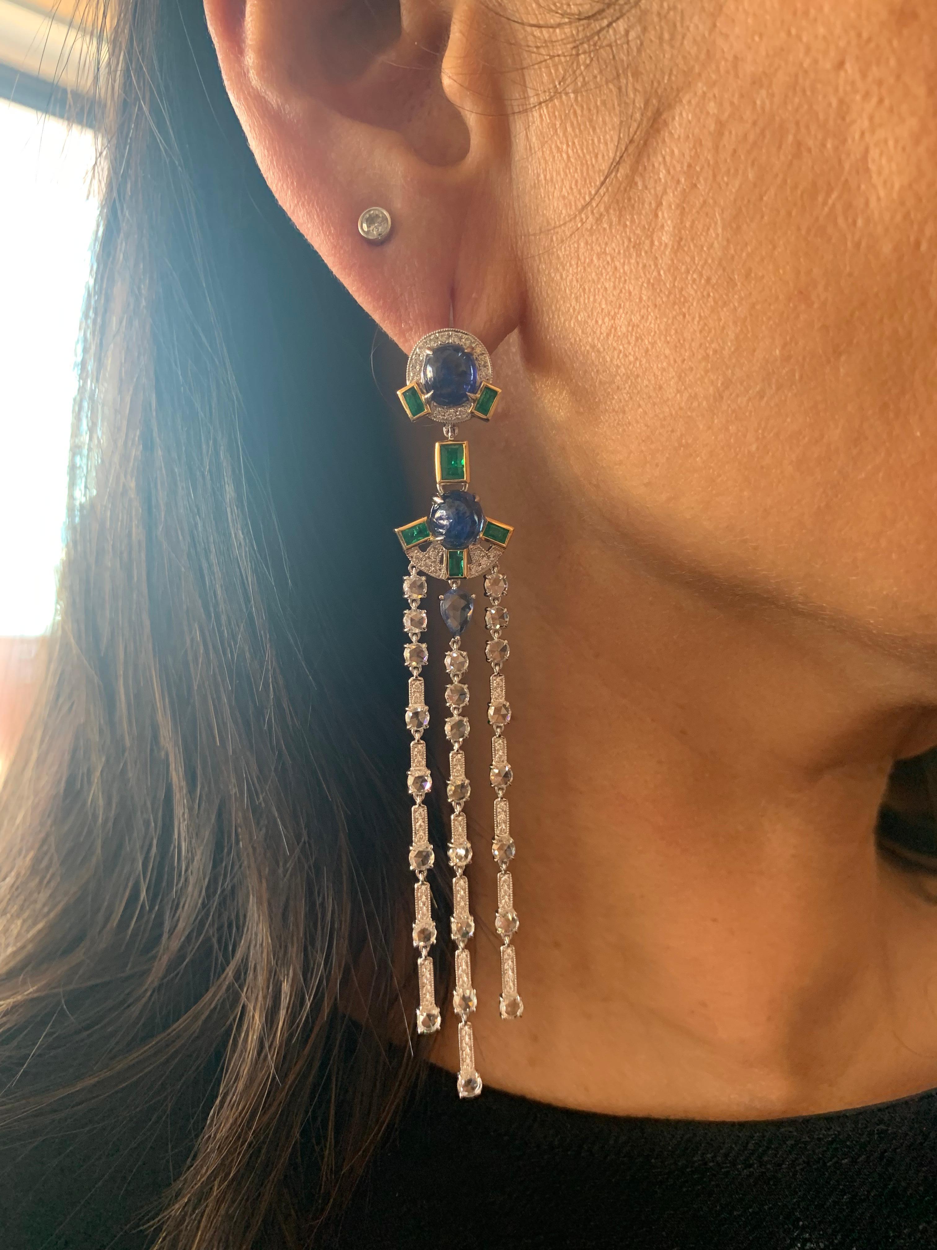 Elegant blue sapphire and emerald dangling earrings that are fun to wear. Crafted using a mix of unique cuts and shapes, these earrings are inspired by art deco and mughal elements. The pop of color with a trendy design makes these an eye-catching