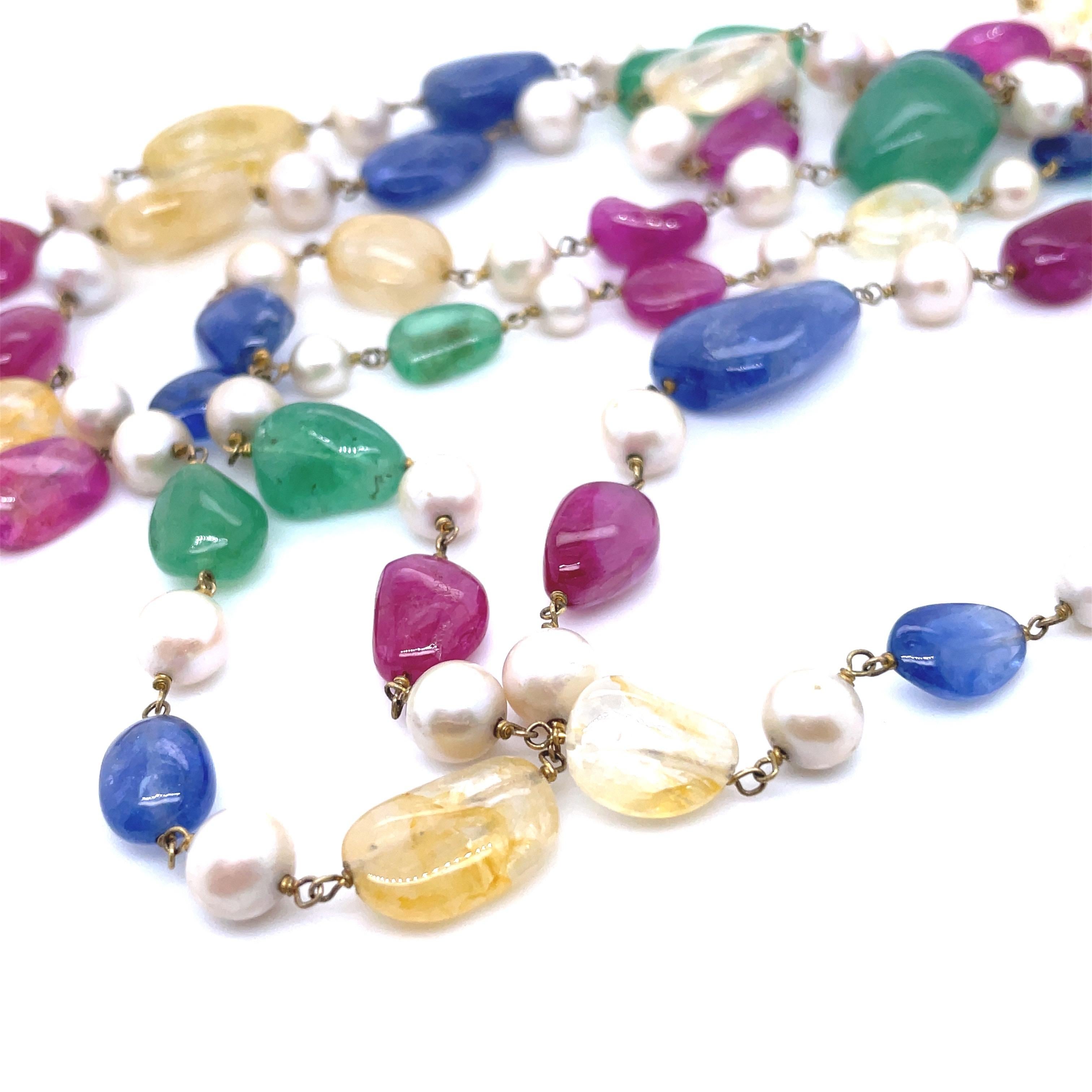 Adorned with an impressive 811.00 carats of vibrant gemstones (Emerald, Ruby, and Blue and Yellow Sapphire), this luxurious piece features three distinct lines of exquisite natural stones interspersed with lustrous gold and radiant pearl