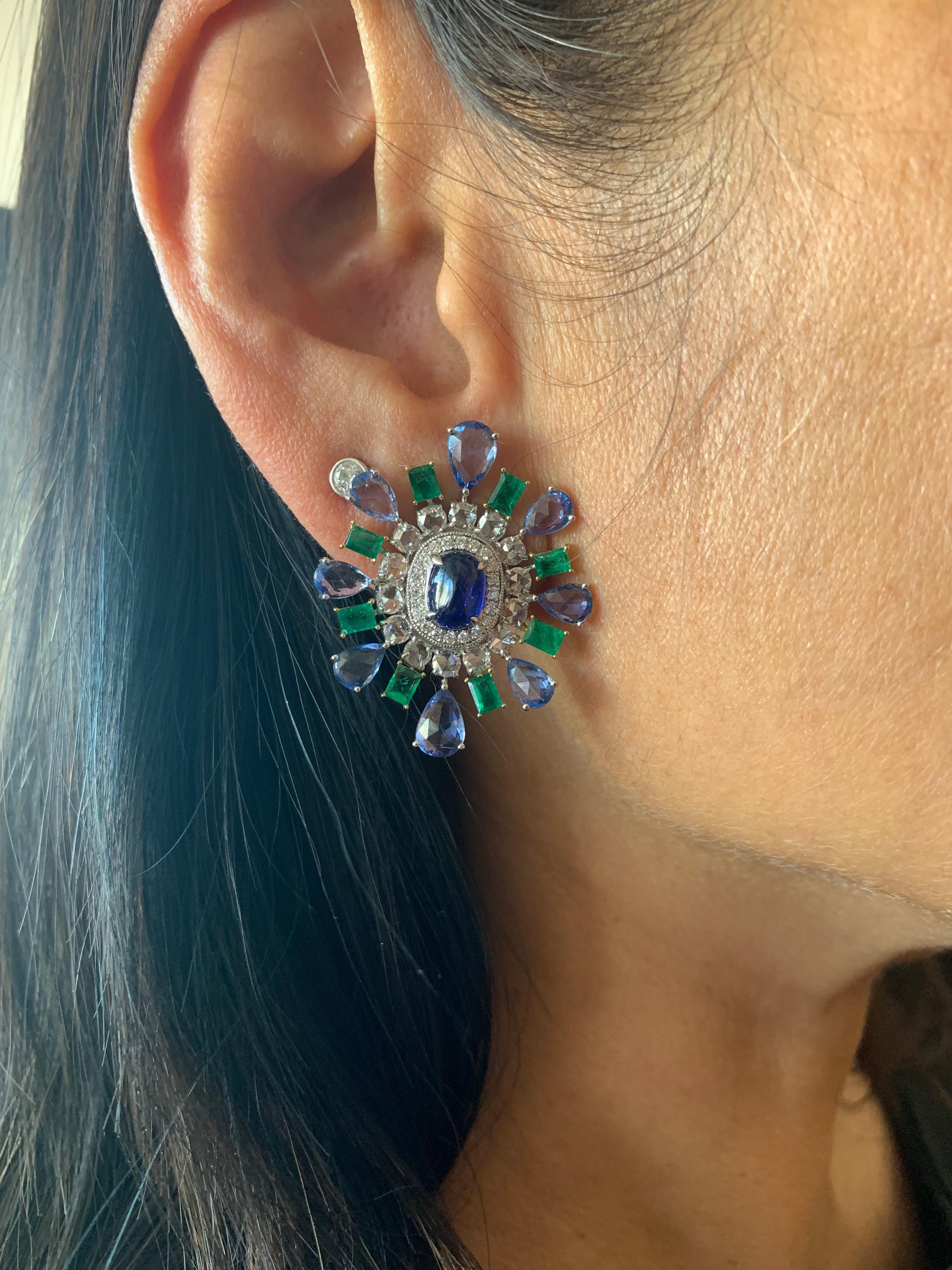 Elegant blue sapphire and emerald stud earrings that are fun to wear. Crafted using a mix of unique cuts and shapes, these earrings are inspired by art deco and mughal elements. The pop of color with a trendy design makes these an eye-catching pair