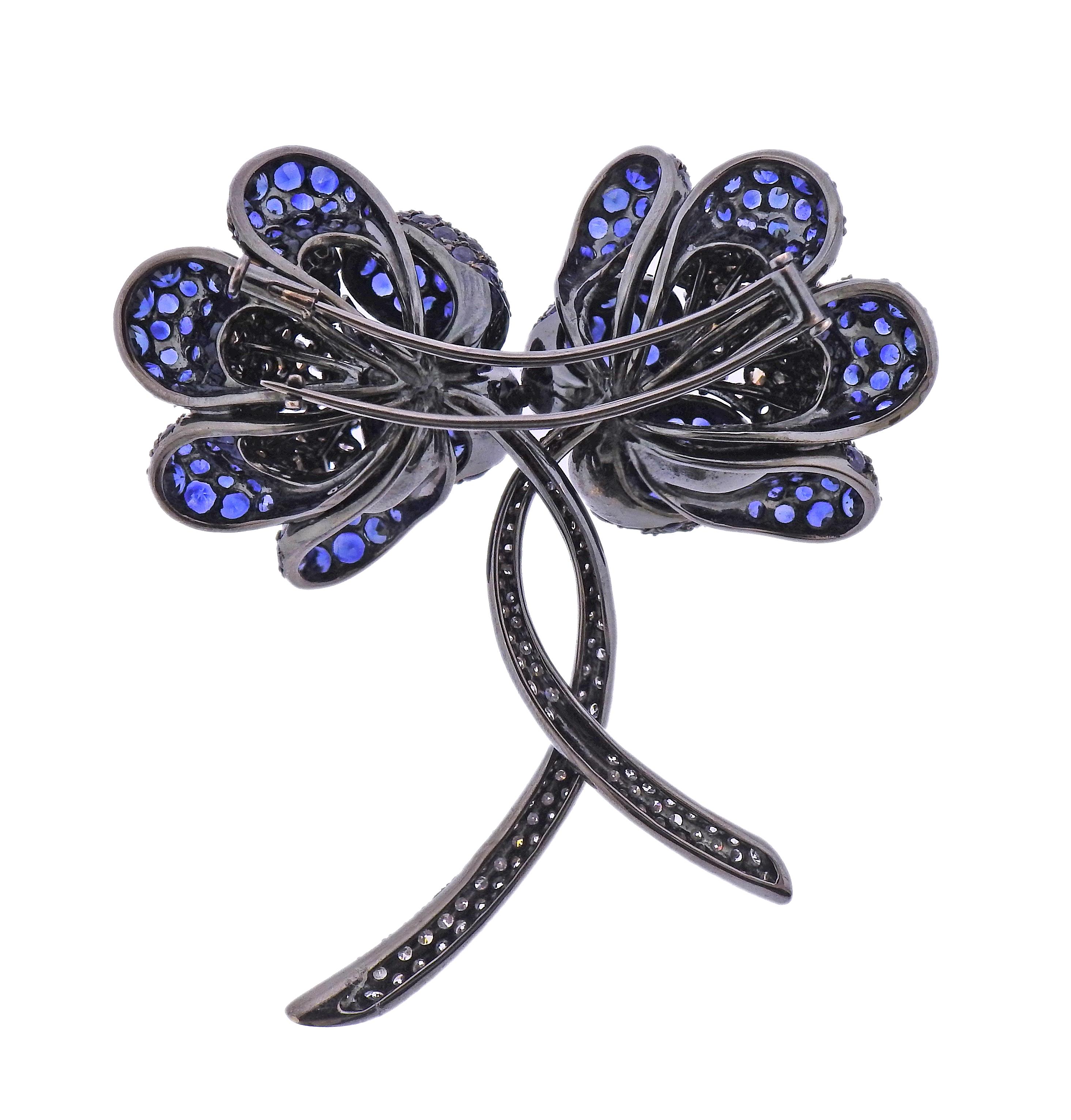 Large 18k blackened gold two flowers brooch, with blue sapphires, approx. 3.50ctw in fancy diamonds ( centers of the flowers) and approx. 1.20ctw in white diamonds (flowers stems). Brooch measures 2.5