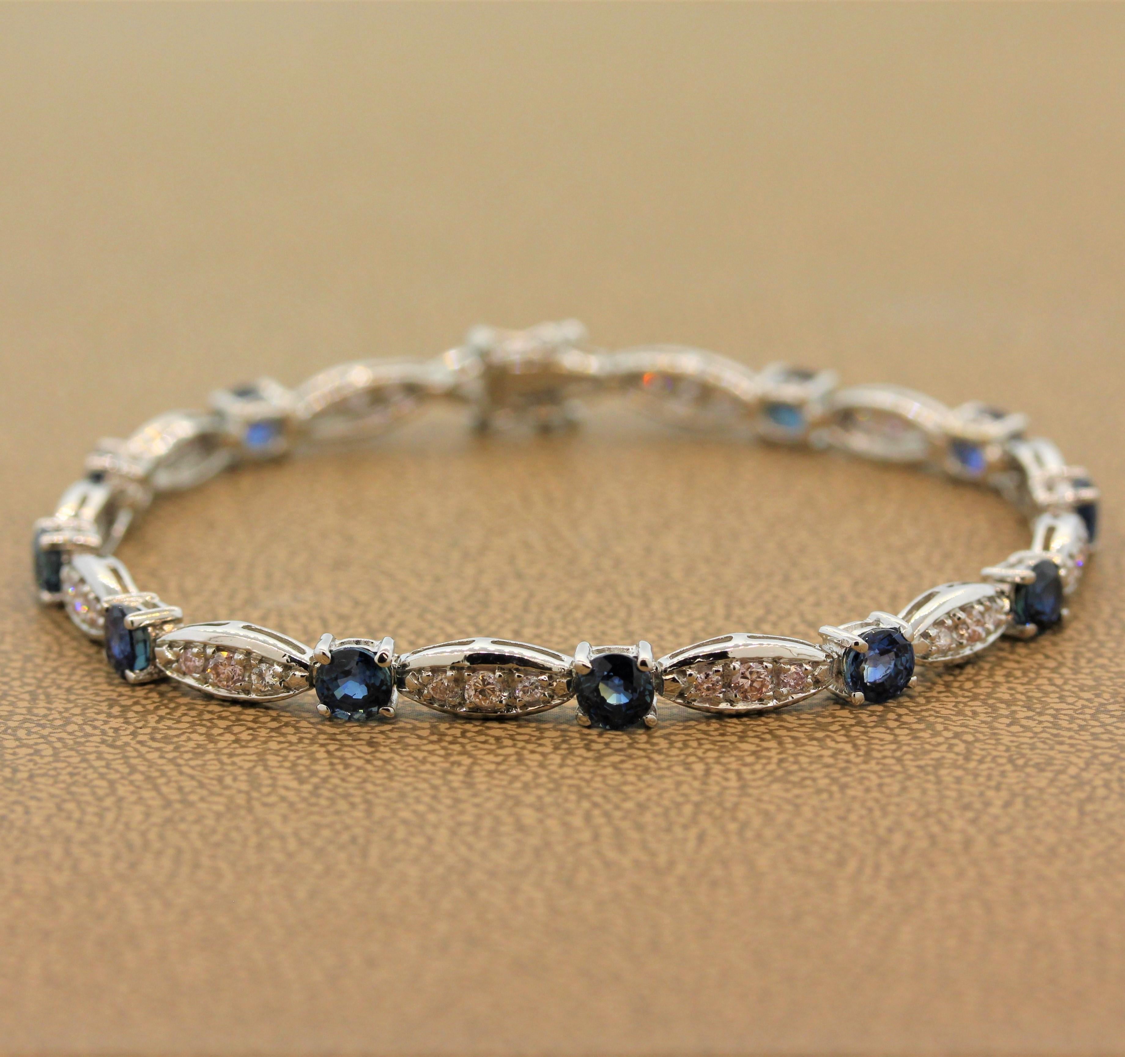 A spectacularly unique bracelet which features both vivid blue sapphire and fancy pink diamonds, a rare combination. The simple yet substantial bracelet is set with 4.25 carats of round blue sapphire and 0.88 carats of fancy pink and colorless