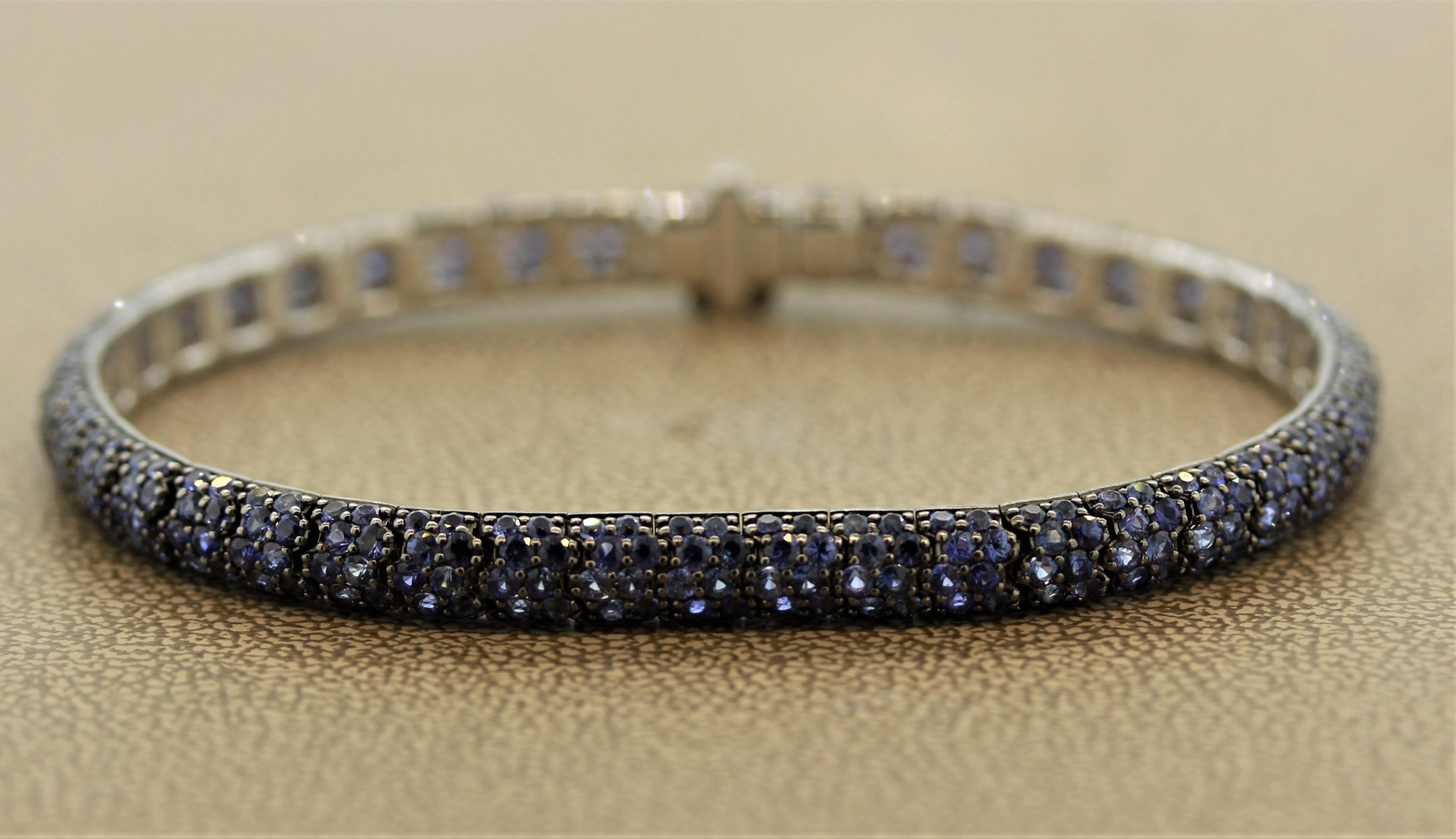 A finely made 18k gold bracelet featuring 14.60 carats of fine blue sapphires. The prongs of sapphires have been rhodium plated to give the piece a black metallic look. The bracelet has a soft flex to it showing its quality.

Length: 7 inches