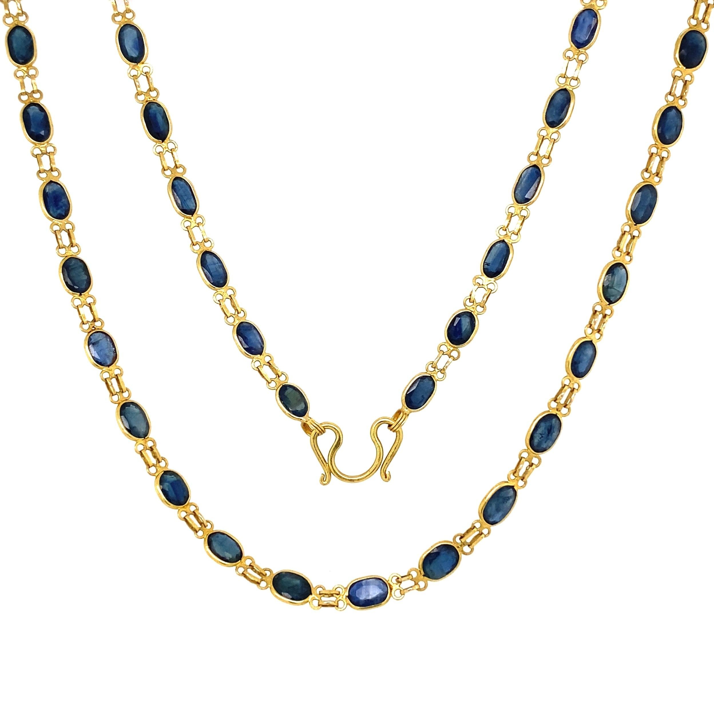 Beautiful, Classic and Chic Long Gold Chain inter-spaced with 70 Oval Blue Sapphires weighing approx. 20tcw. Necklace measures 27” long. Hand set Sapphires and Hand crafted ion 22K yellow Gold. So easy to wear...A piece you'll turn to time and time