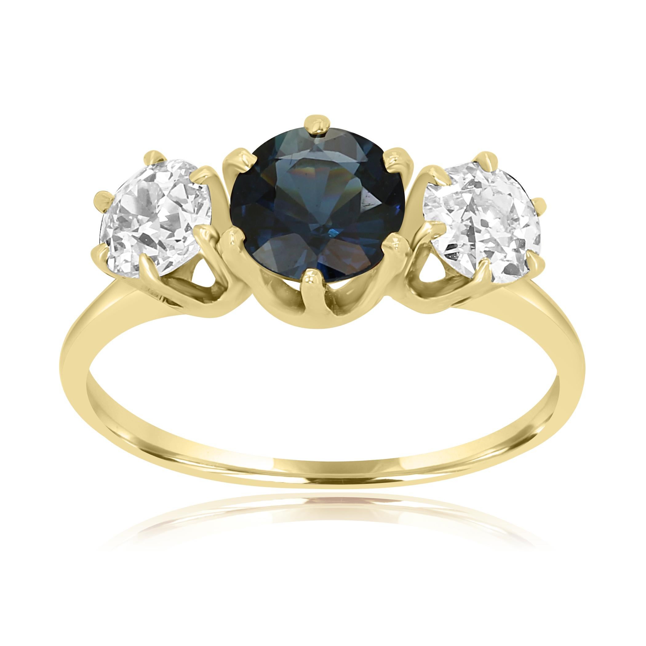 Gorgeous Blue Sapphire Round 1.50 Carats Flanked With 2 White Old European Cut VS-SI Clarity Diamonds 1.10 Carat on the side in 14K Yellow Gold Classic Ring.

MADE IN USA
Center Blue Sapphire Round Weight 1.50 Carat
Total Weight 2.60 Carat