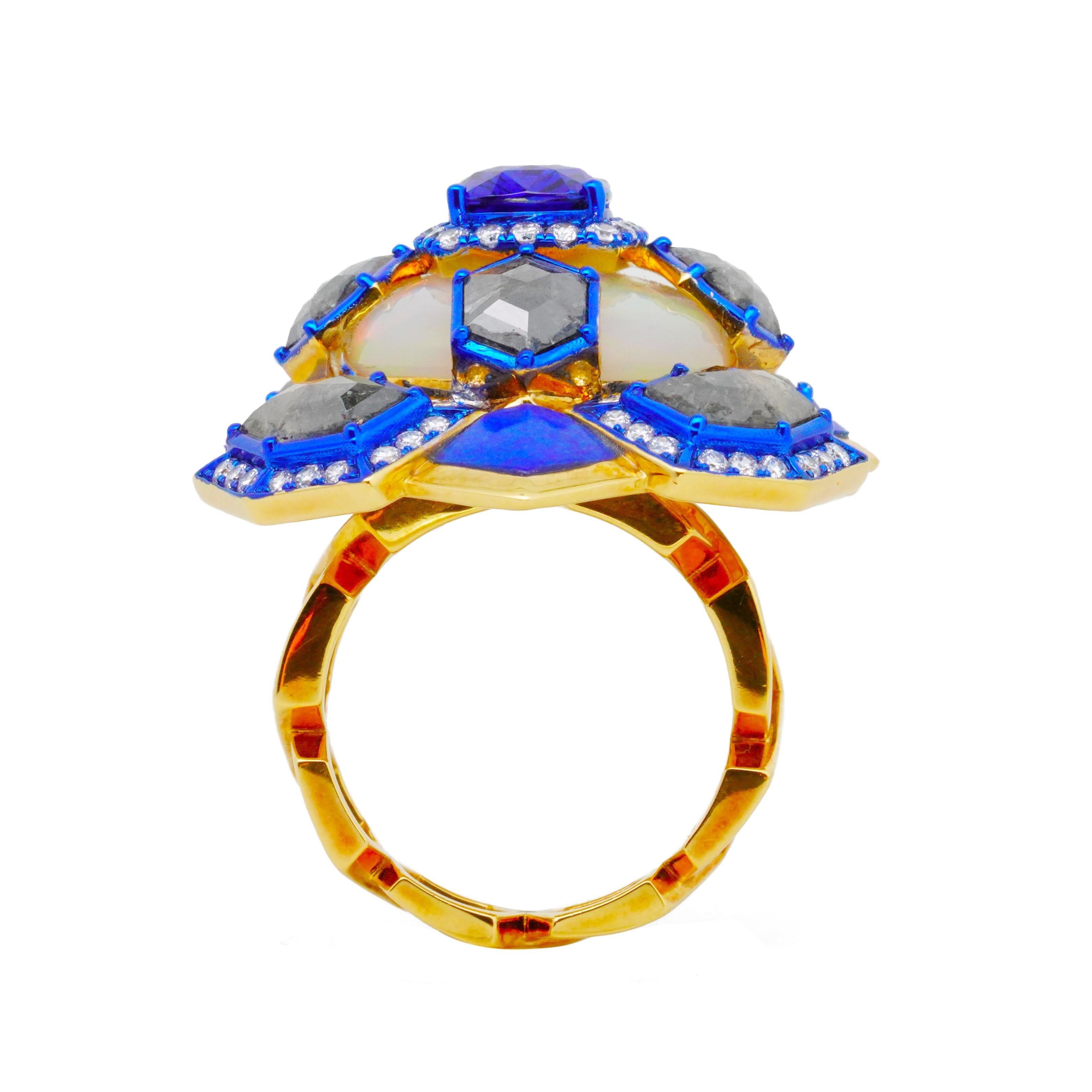 The Blue-Awakening Ring from The Psychedelic Light Collection by Austy Lee features a 2.24-carat Sri Lankan Royal-Blue Sapphhire, which is set on top of a 8.75-carat Euthopian Opal. The ring is decorated with flat-cut raw diamonds, lapis lazuli and