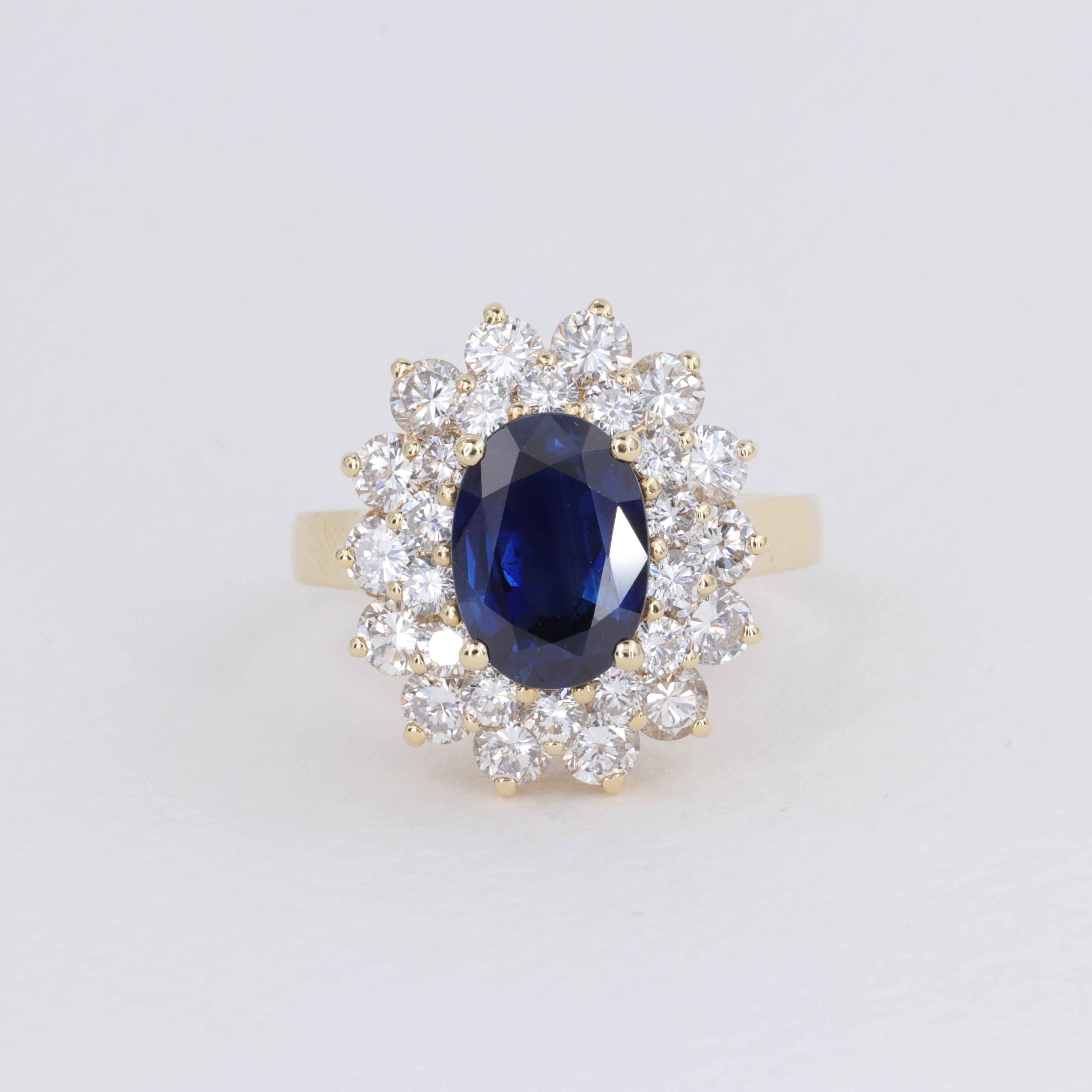 Oval Cut Blue Sapphire Oval and Diamond Halo Ring by Mayors in 18 Karat Yellow Gold For Sale
