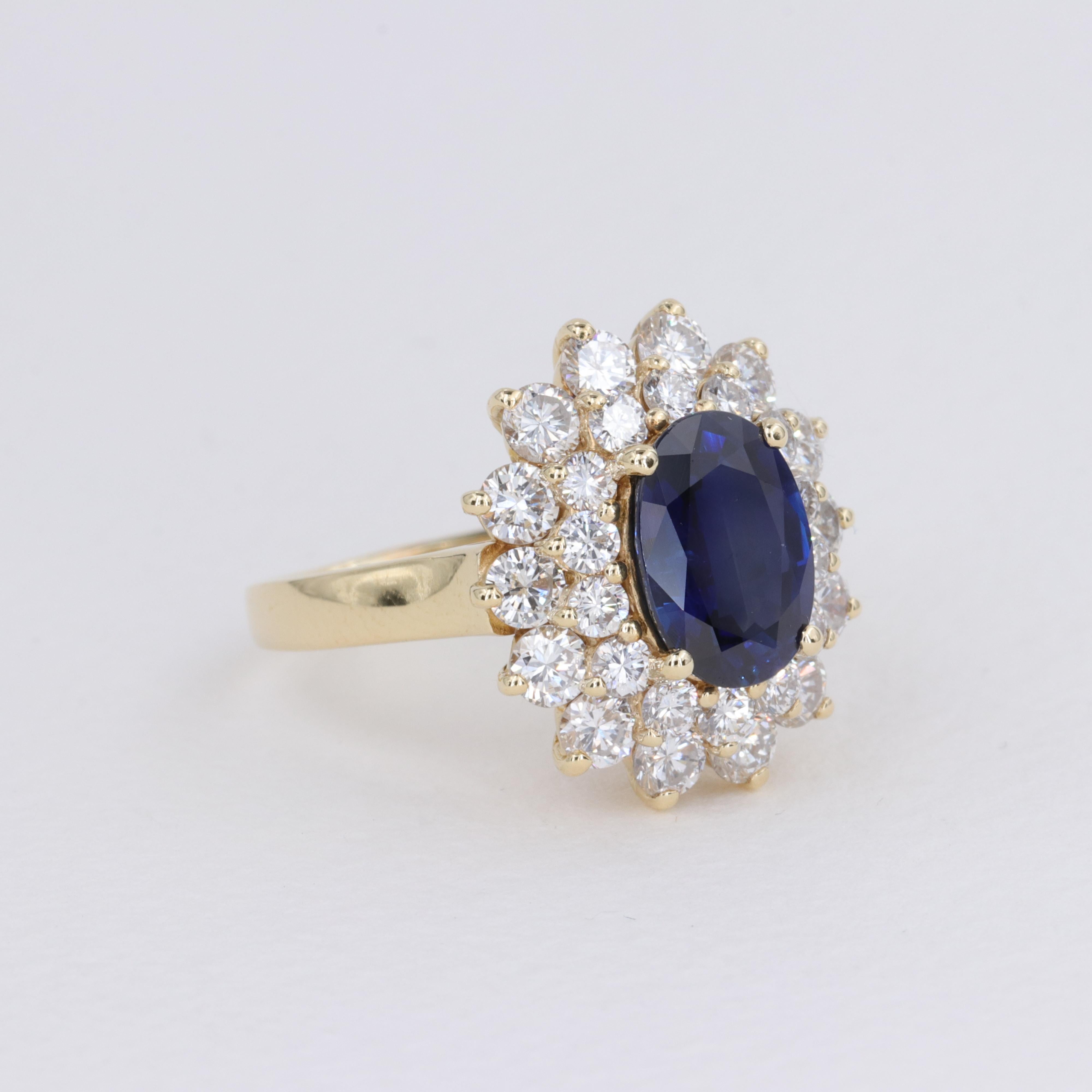 Blue Sapphire Oval and Diamond Halo Ring by Mayors in 18 Karat Yellow Gold In Excellent Condition For Sale In Tampa, FL