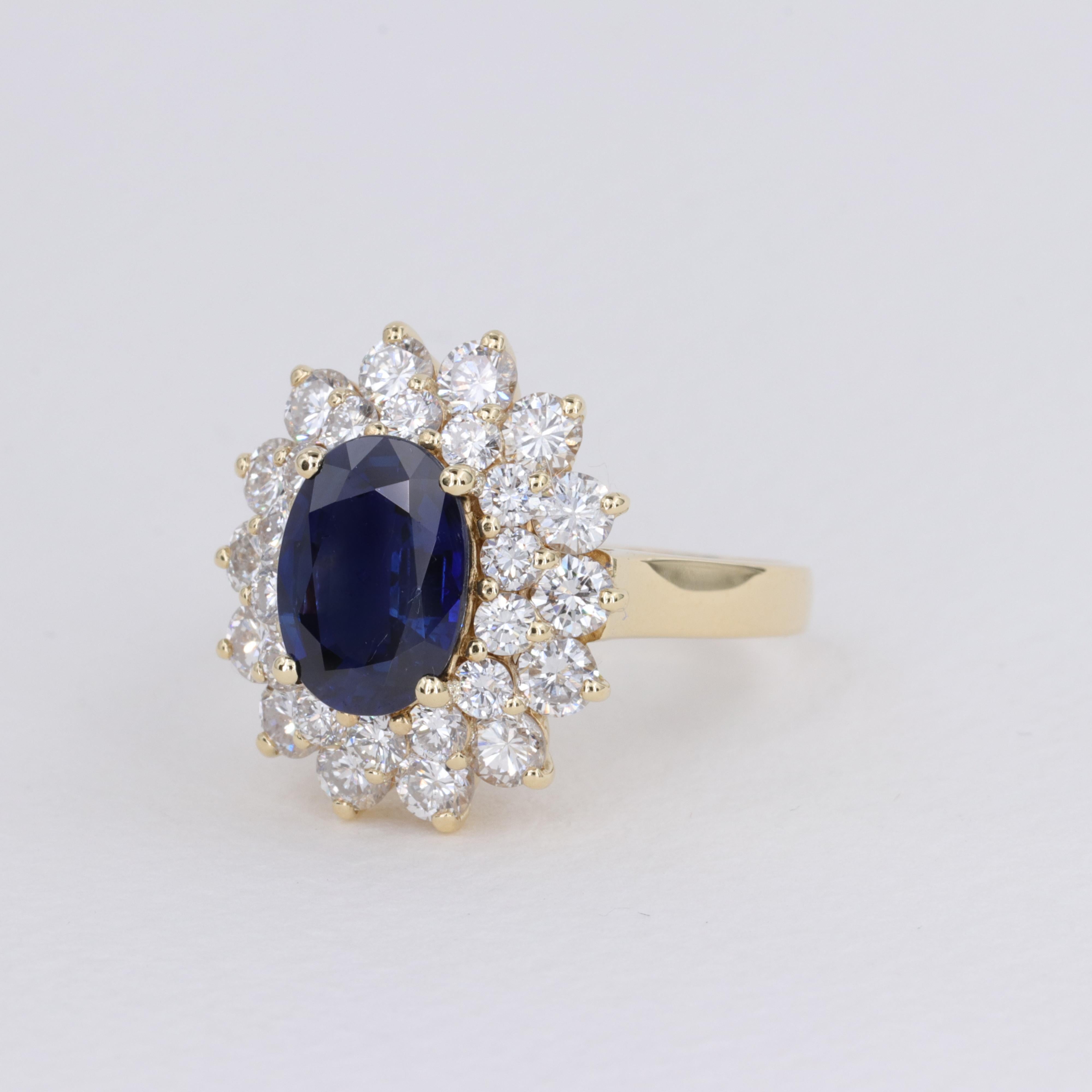Women's or Men's Blue Sapphire Oval and Diamond Halo Ring by Mayors in 18 Karat Yellow Gold For Sale