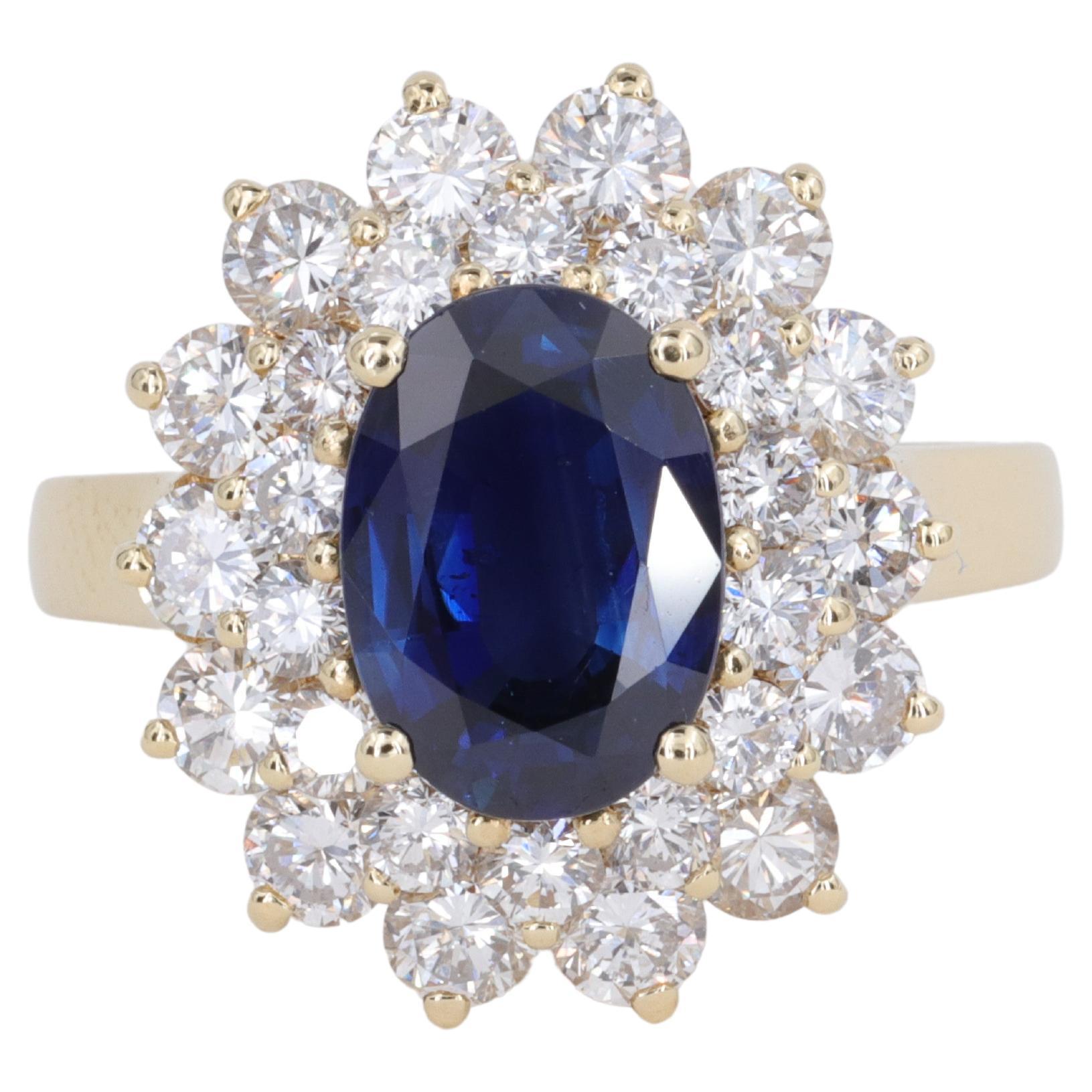 Blue Sapphire Oval and Diamond Halo Ring by Mayors in 18 Karat Yellow Gold For Sale