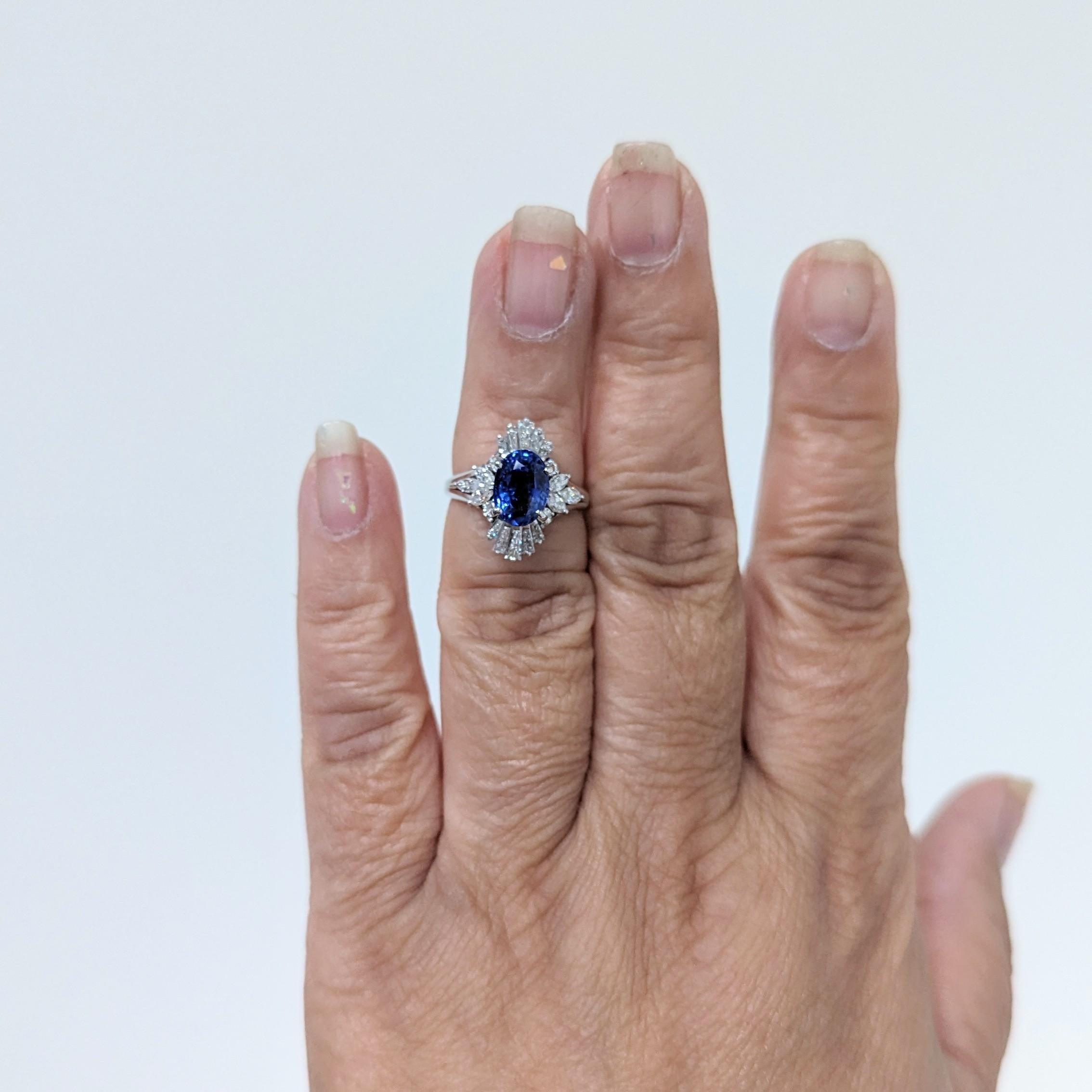 Gorgeous 3.39 ct. blue sapphire oval with 1.04 ct. good quality, white, and bright diamond baguettes and marquise shapes.  Handmade in platinum.  Ring size 5.5.