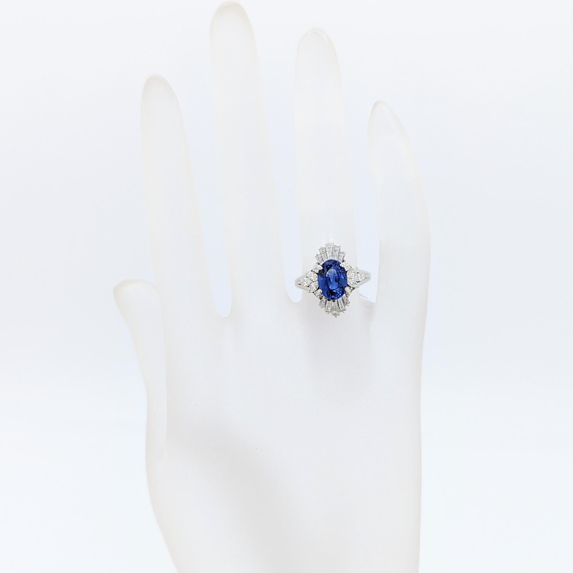 Oval Cut Blue Sapphire Oval and White Diamond Cluster Ring in Platinum