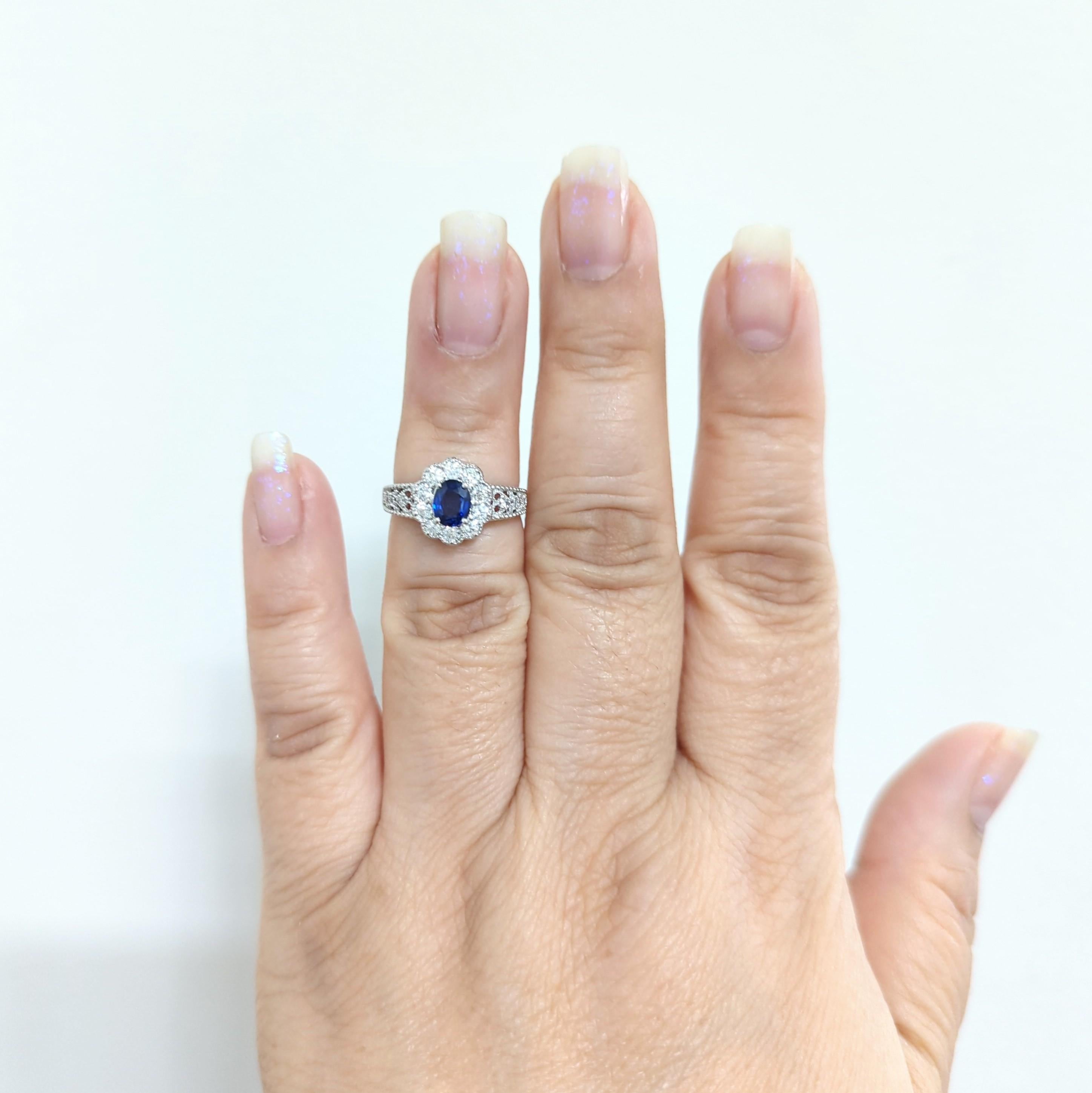 Beautiful deep blue sapphire oval weighing 0.80 ct. with 0.48 ct. of good quality white diamond rounds in a handmade platinum mounting.  Ring size is 5.75.  Estate piece in excellent condition.