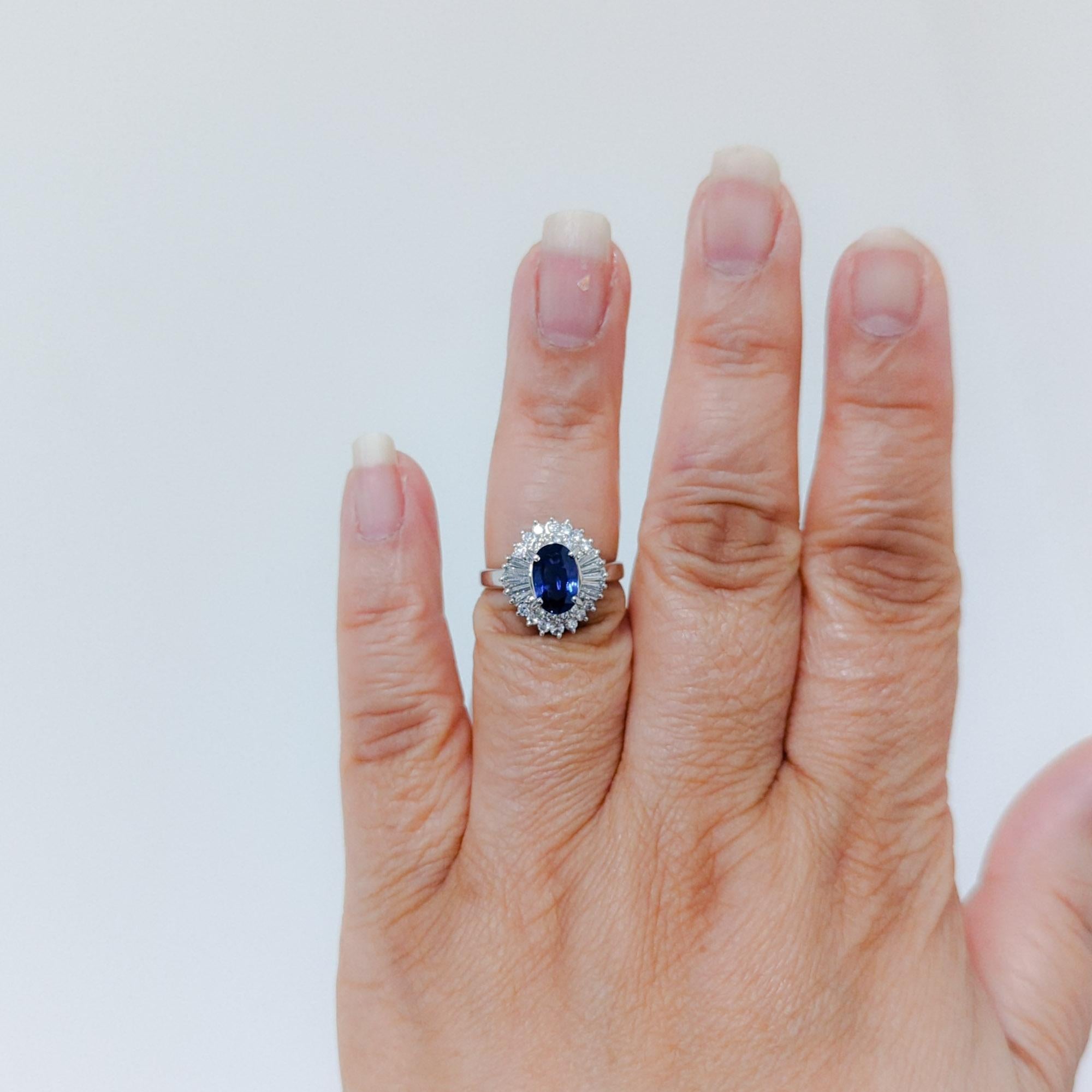 Beautiful 1.58 ct. blue sapphire oval with 0.63 ct. good quality, white, and bright diamond baguettes.  Handmade in platinum.  Ring size 6.5.