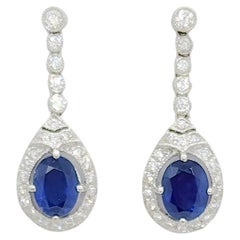 Blue Sapphire Oval and White Diamond Dangle Earrings in 18k White Gold