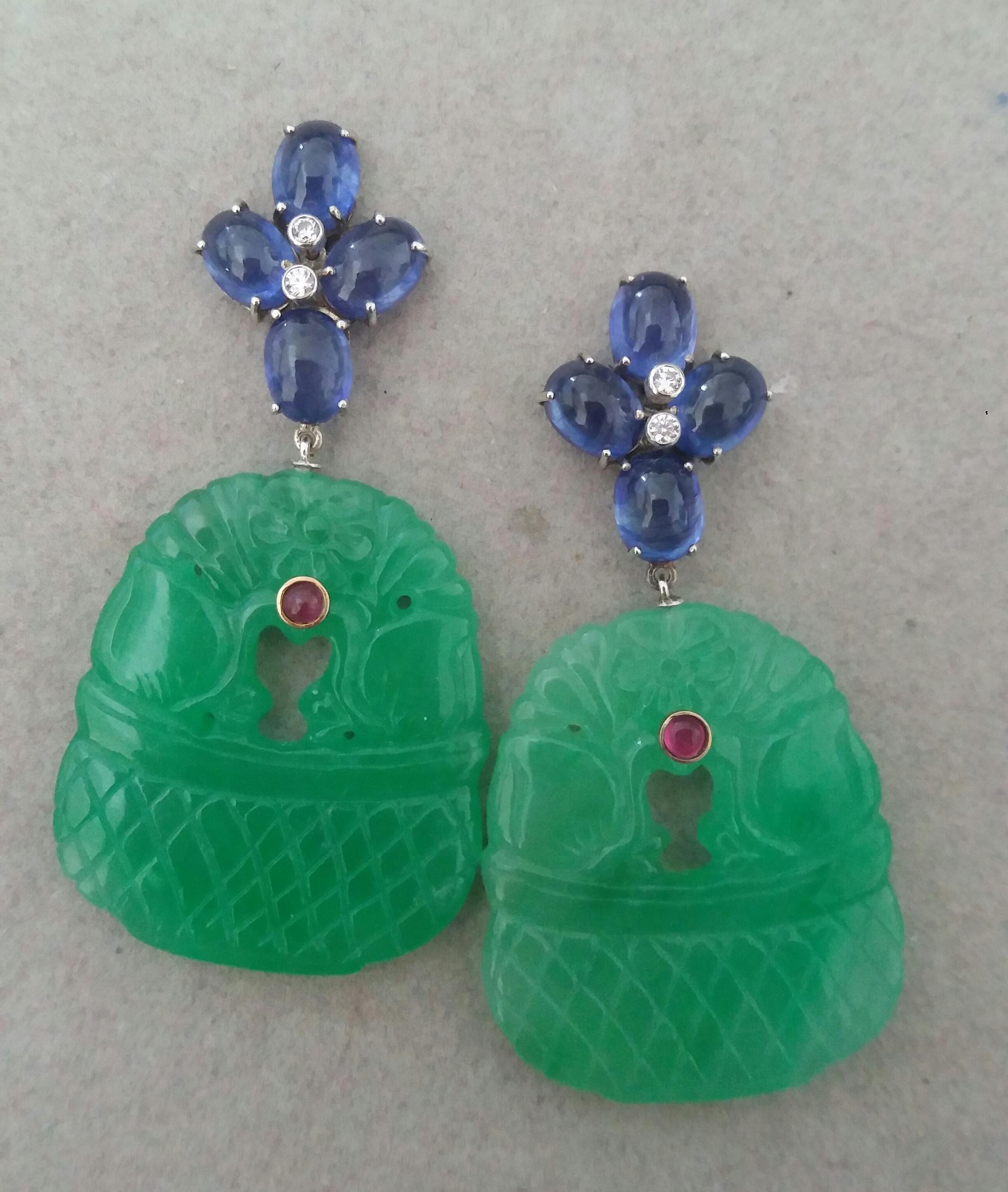 Elegant and completely handmade Earrings consisting of an upper part of 4 oval shape Blue Sapphires 6x8 mm  set together in 14 Kt yellow gold with 2 small diamonds in the center, at the bottom we have 2 Carved Jades measuring 30mmx35mm, depicting