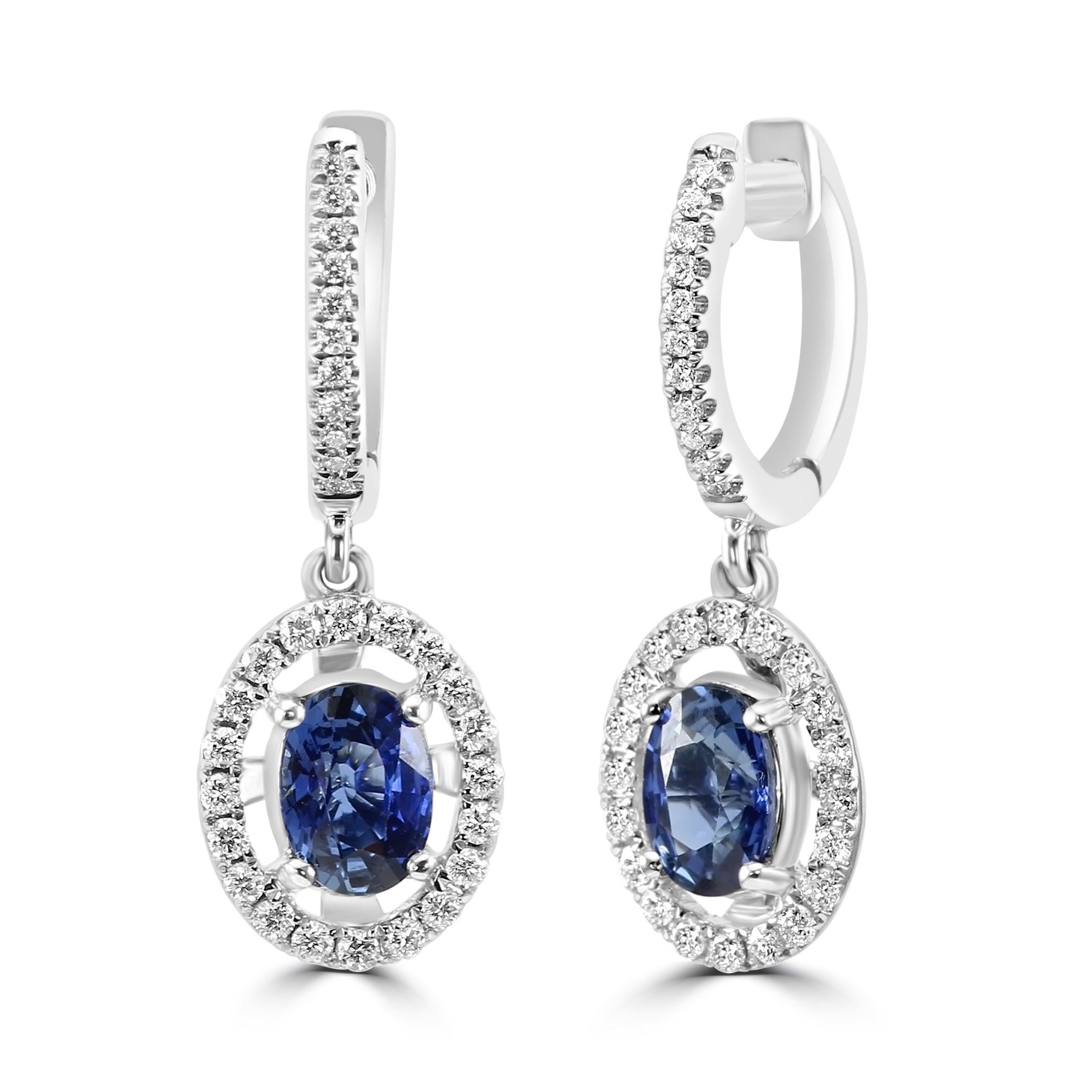Each earring features a captivating blue sapphire oval shaped center stone, totaling to 1.90 carats. The rich, deep blue hue of the sapphires is beautifully highlighted by a sparkling halo of white diamond rounds, totaling to 0.36 carats.

Set in