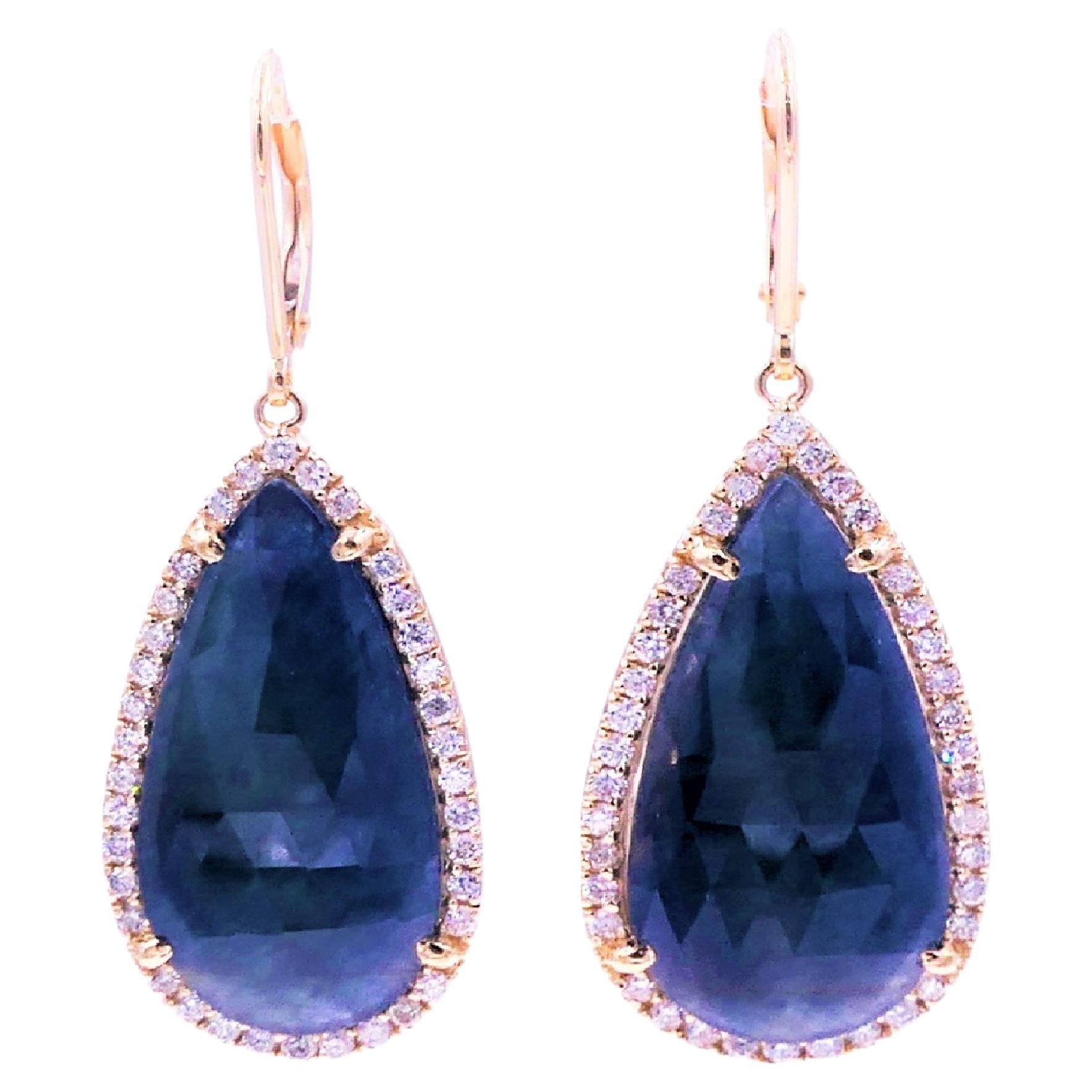 Blue Sapphire Pear Drop Faceted Cabochon Diamond Halo Drop 18K Gold Earrings
18 Karat Yellow Gold
1.00 CT Diamonds
Dark Blue Sapphire Faceted Cabochon Slices 

Important Information:
Please note that this item will take 2-4 weeks to deliver - it is