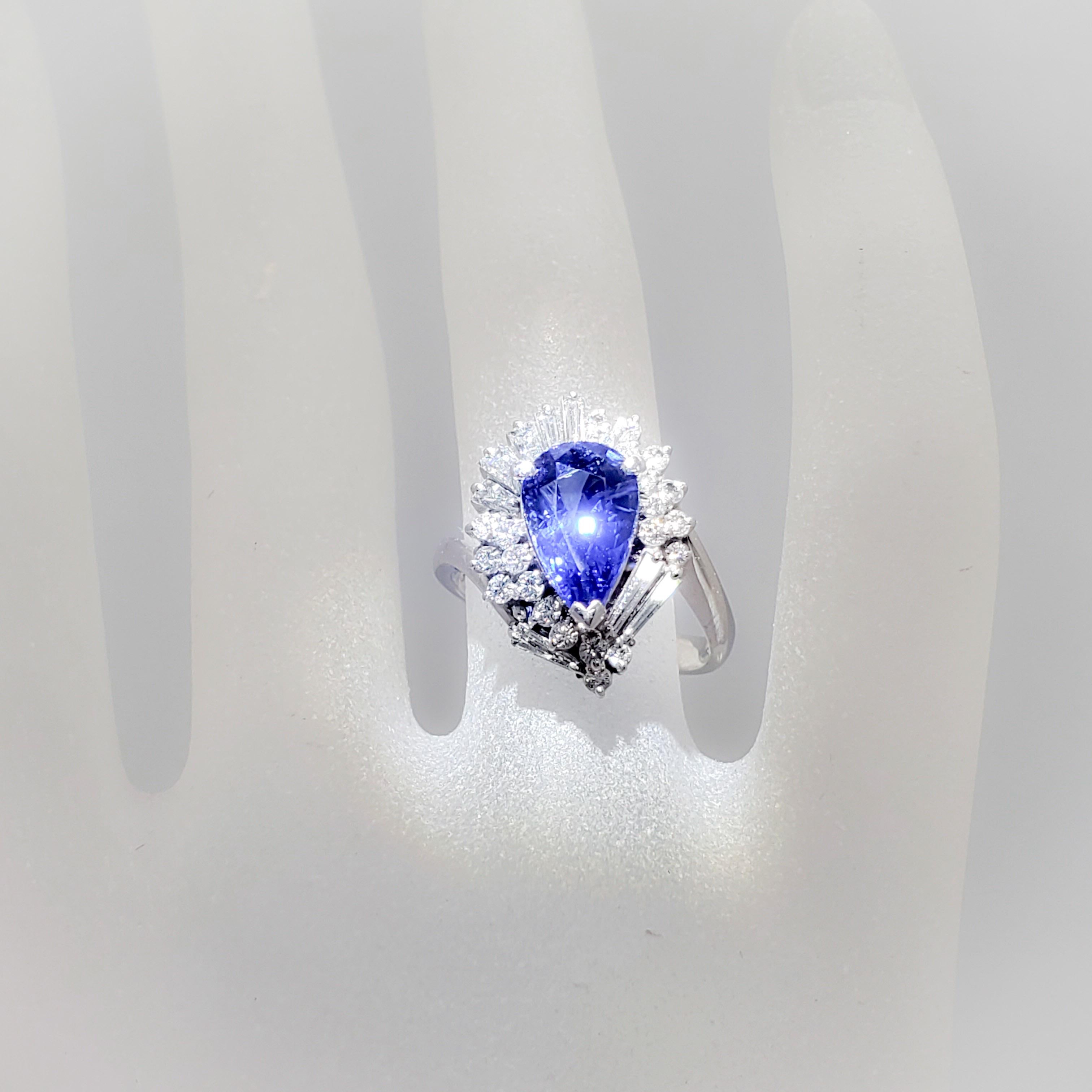 Gorgeous estate deep hue blue sapphire pear weighing 2.91 cts with 0.80 cts of good quality, white, and bright diamond baguettes and rounds.  Handmade in platinum with approximately 9.20 grams of metal.  Size 6.75.  Excellent condition.